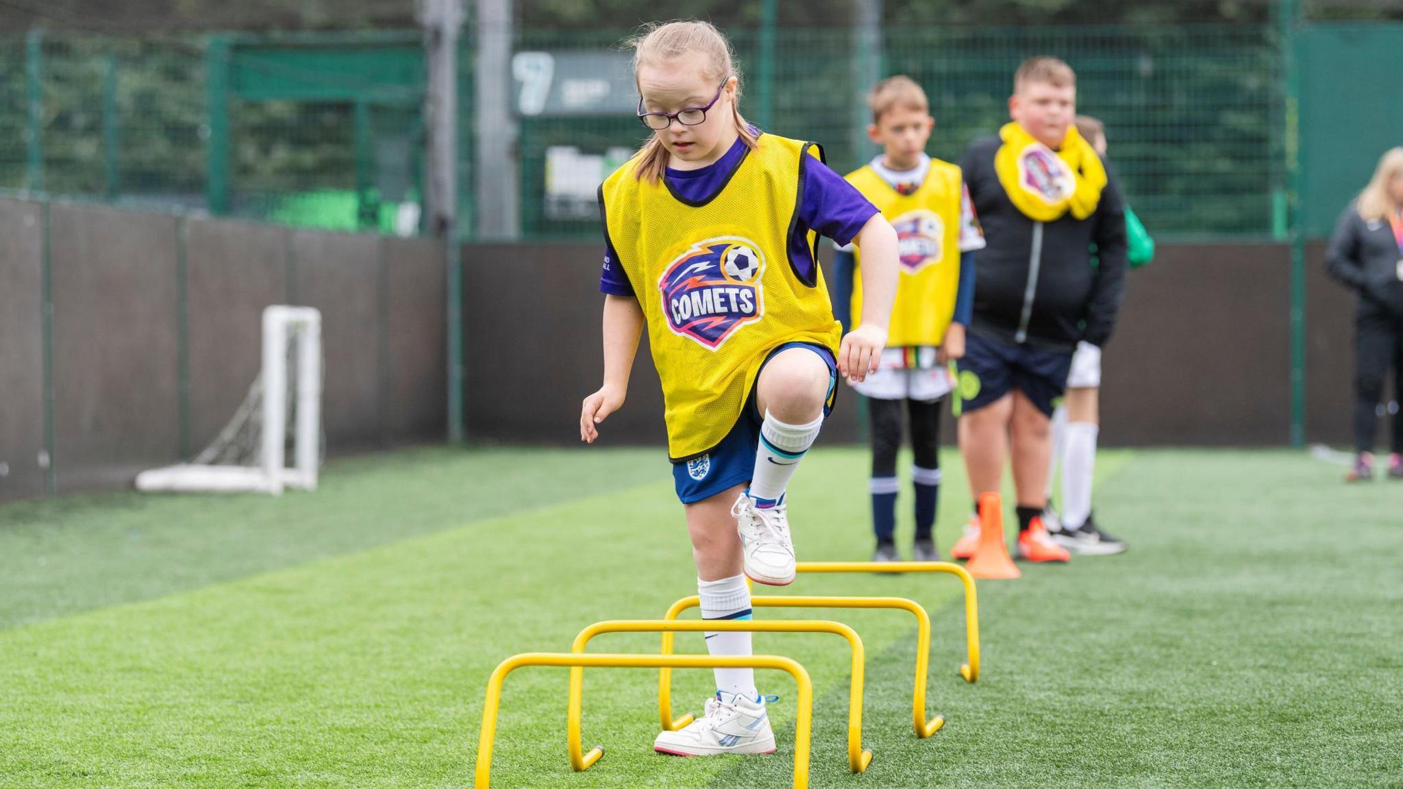 Girl doing football training.