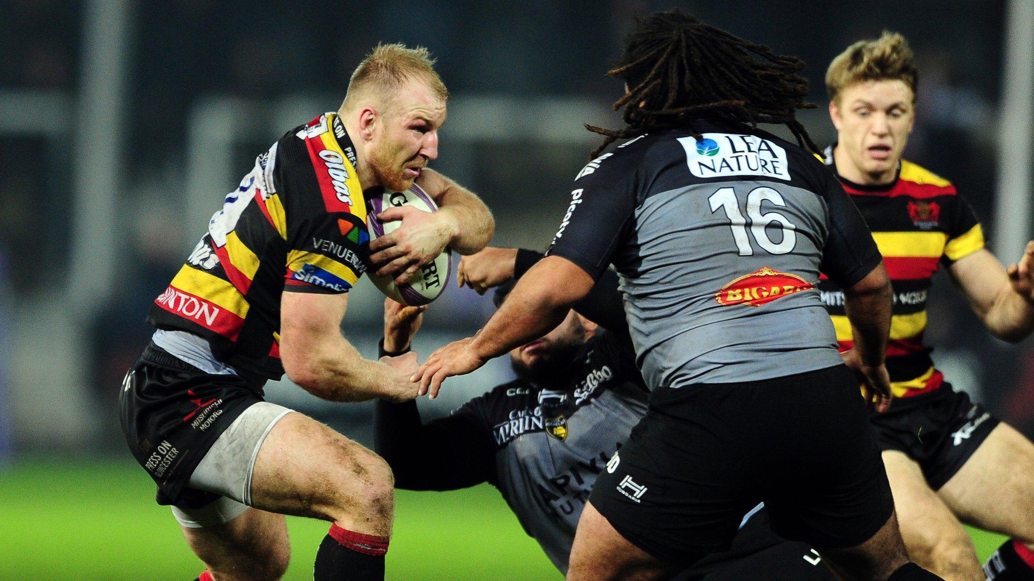 Matt Kvesic of Gloucester Rugby is tackled by Maxime Gau of La Rochelle