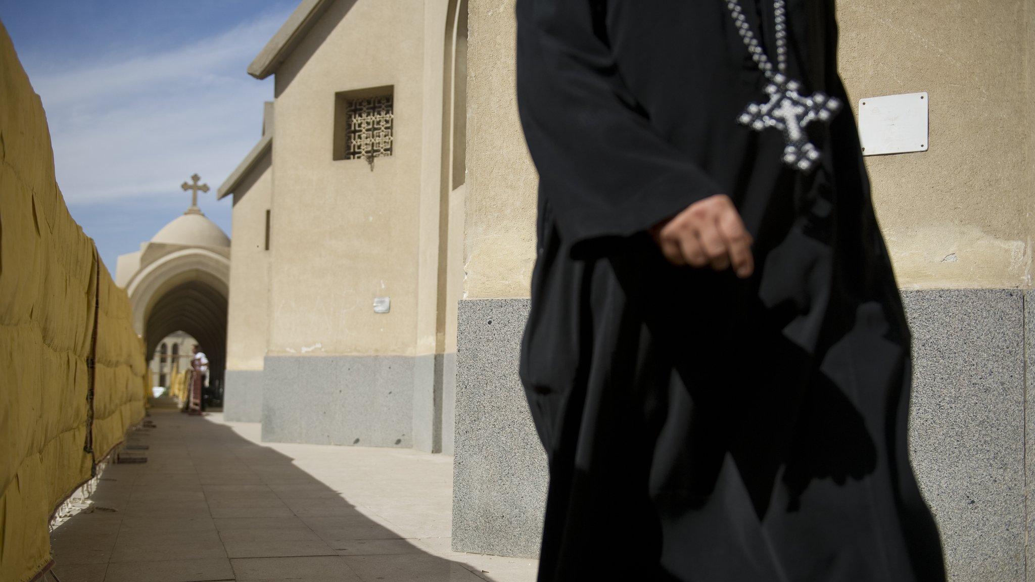 A Coptic Christian priest enters Saint Mark's Cathedral on November 4, 2012 in Cairo,