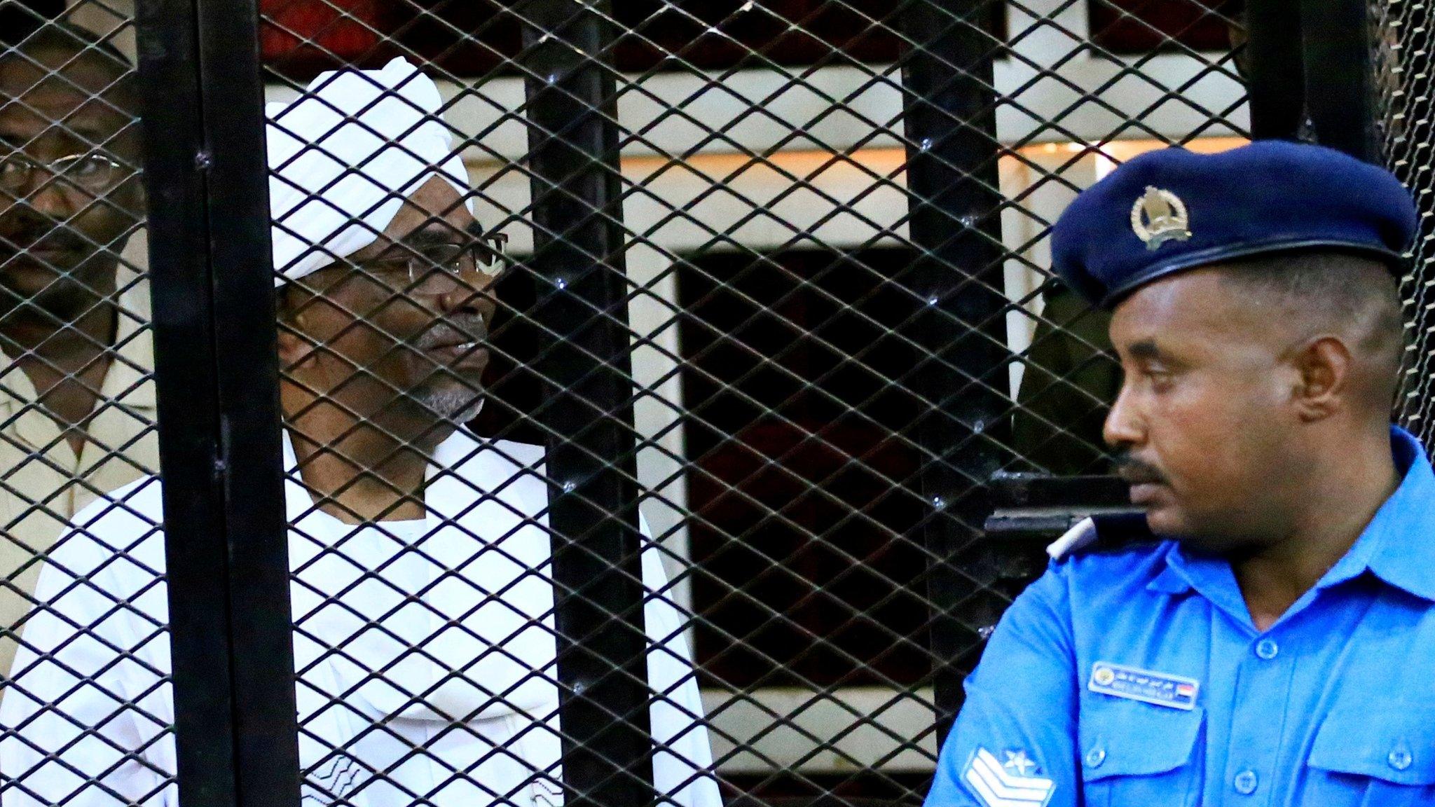 Omar Hassan al-Bashir sits inside a cage during a hearing of the verdict that convicted him of corruption charges in a court in Khartoum, Sudan, December 14, 2019