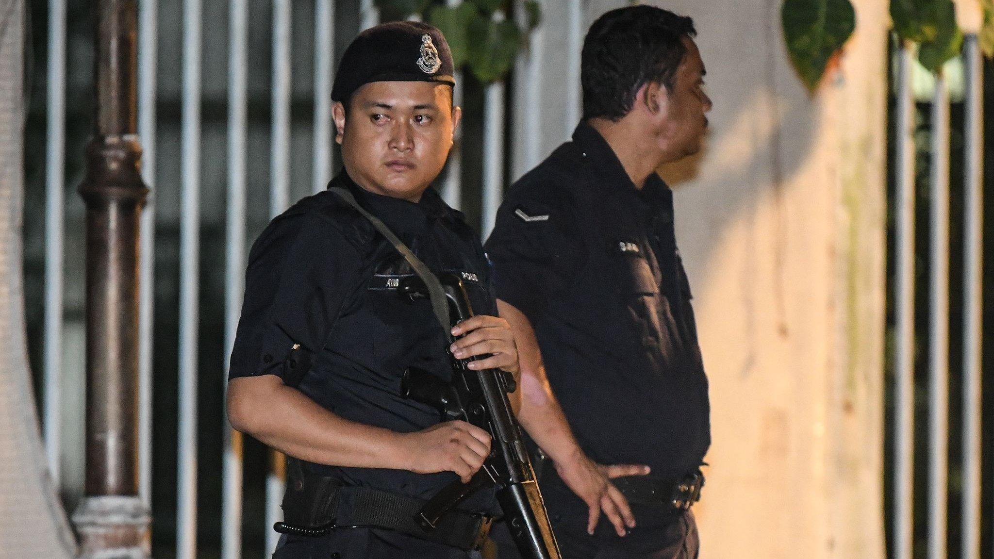 Malaysian policeman stand at the entrance of the former Prime Minister Najib Razak's residence in Kuala Lumpur on May 16, 2018