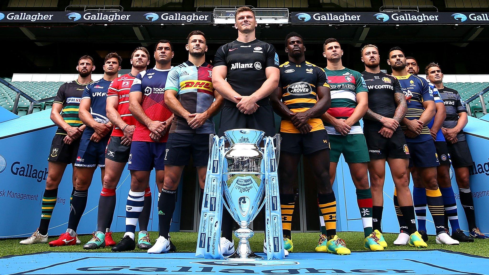 Premiership club representatives pose with the trophy