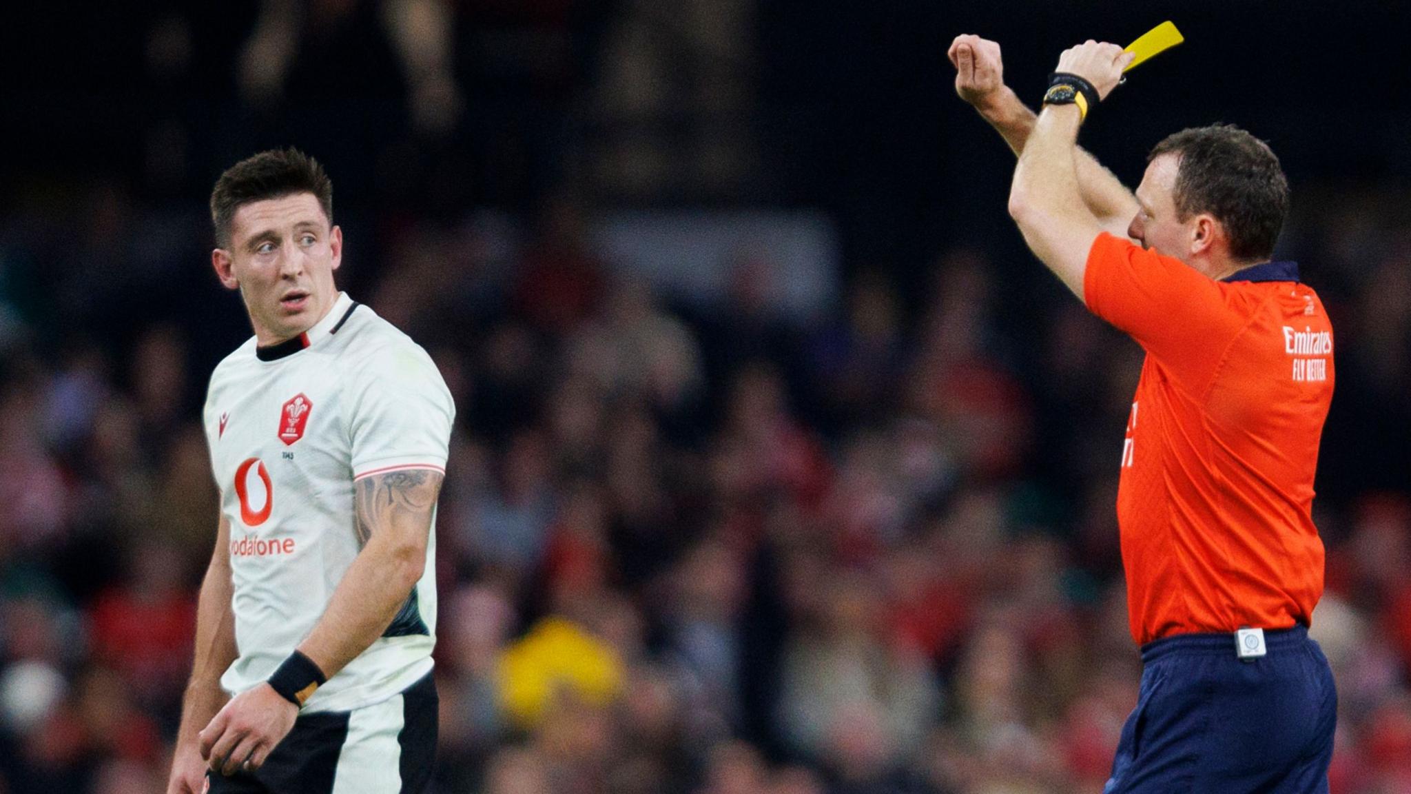 Wales wing Josh Adams is shown a yellow card by referee Matthew Carley that was upgraded to red