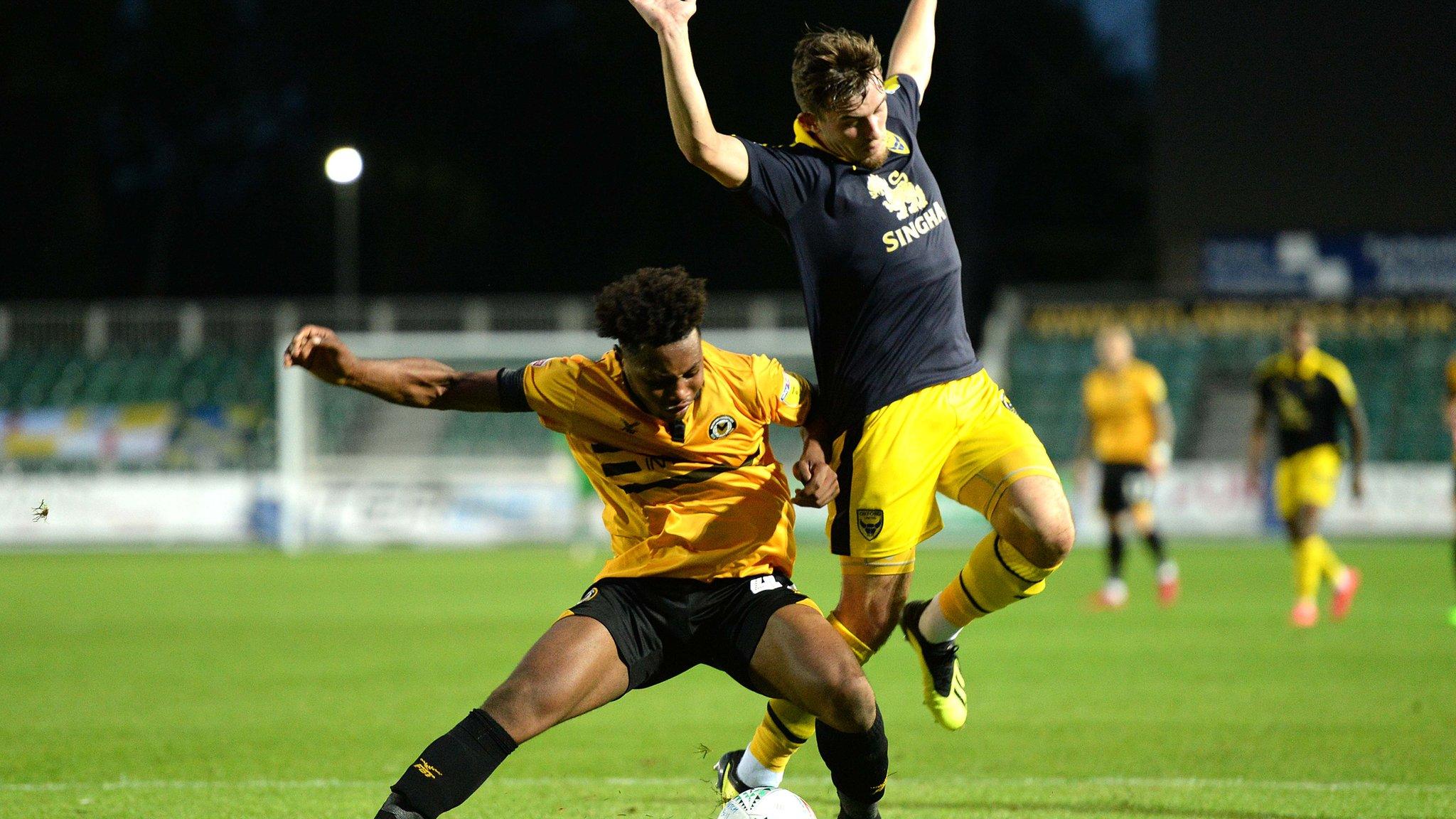Antoine Semenyo of Newport County is tackled by Jamie Hanson of Oxford United