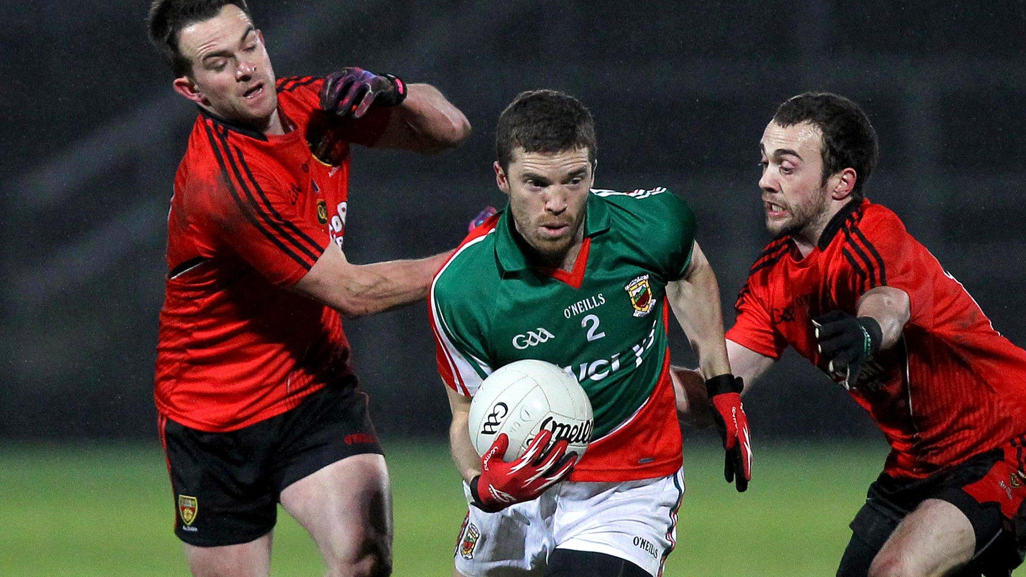 Down pair Mark Poland and Conor Laverty challenge Mayo's Chris Barrett