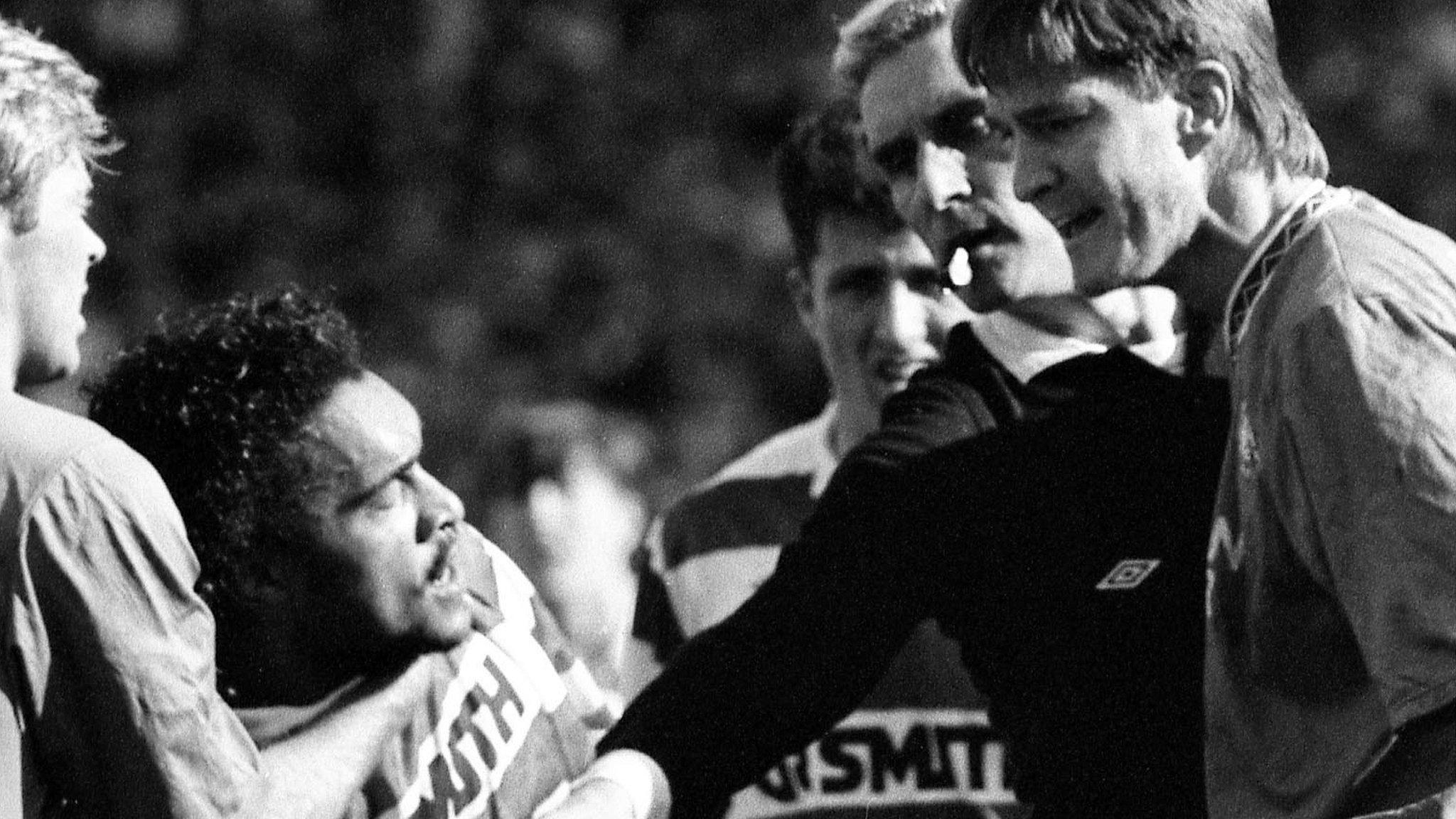 Former Celtic defender Paul Elliott (left) is confronted by Rangers counterpart Richard Gough in 1991