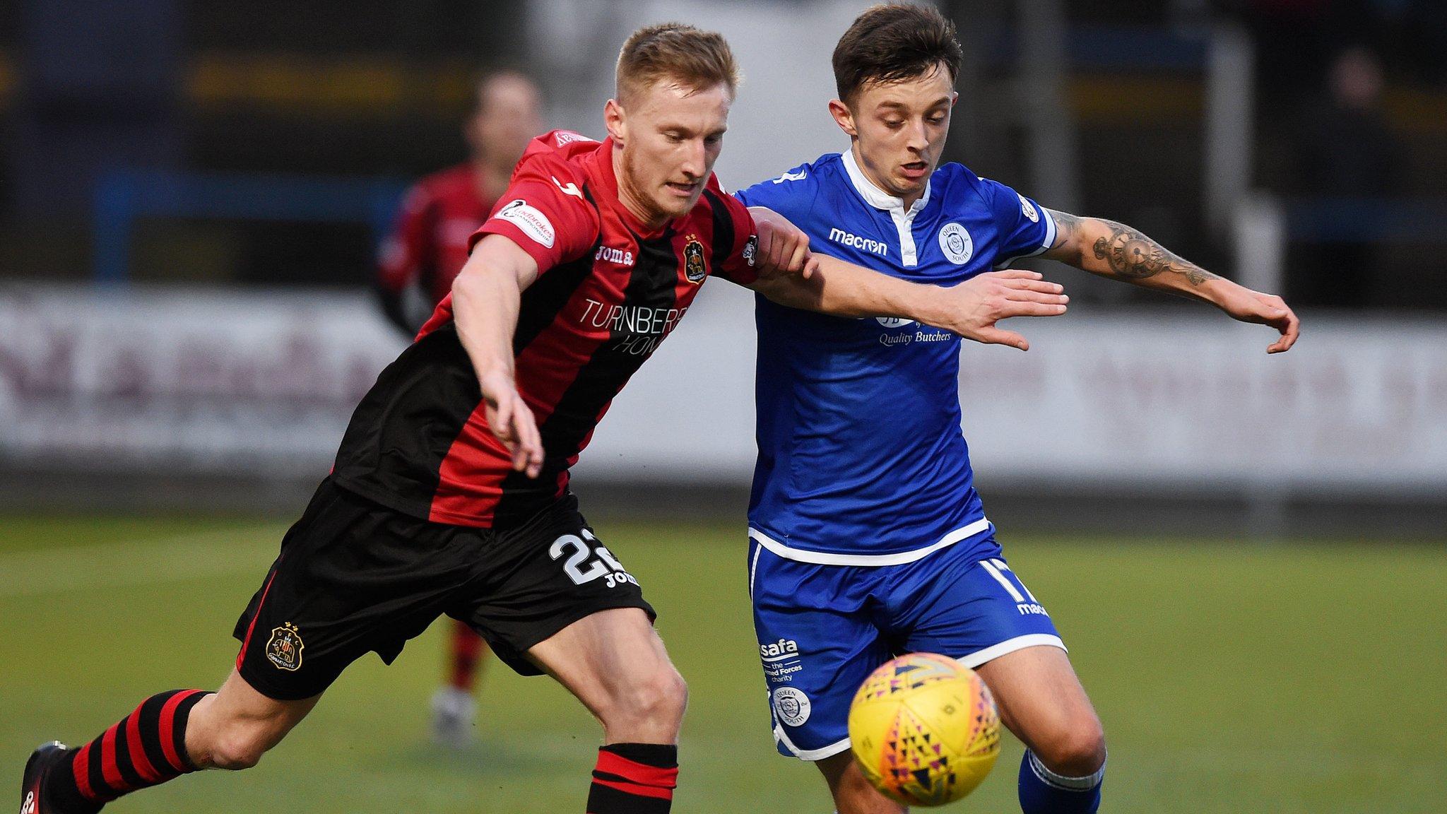 Queen of the South's Connor Murray battles for the ball with Dumbarton's Liam Dick