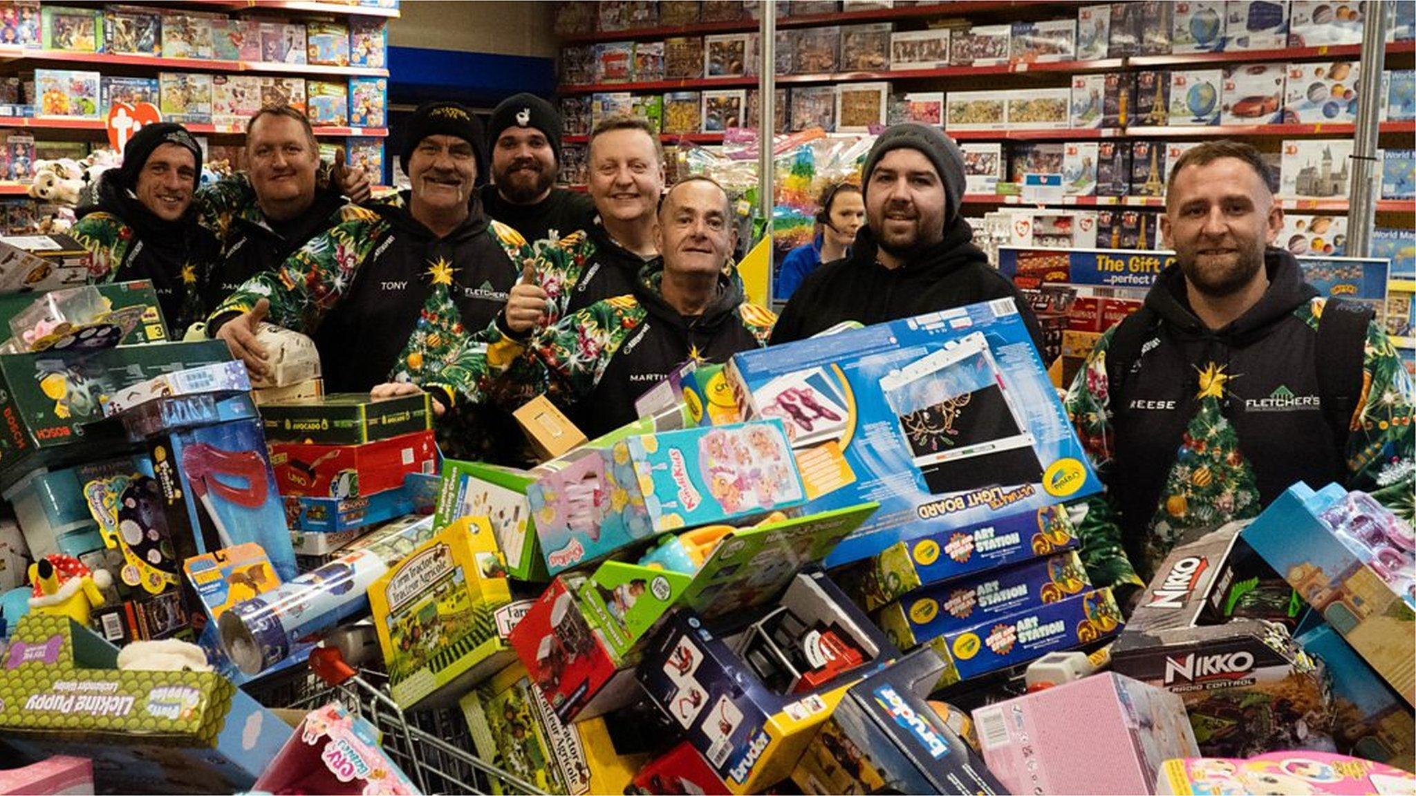 Reese and his team with trolleys filled with toys