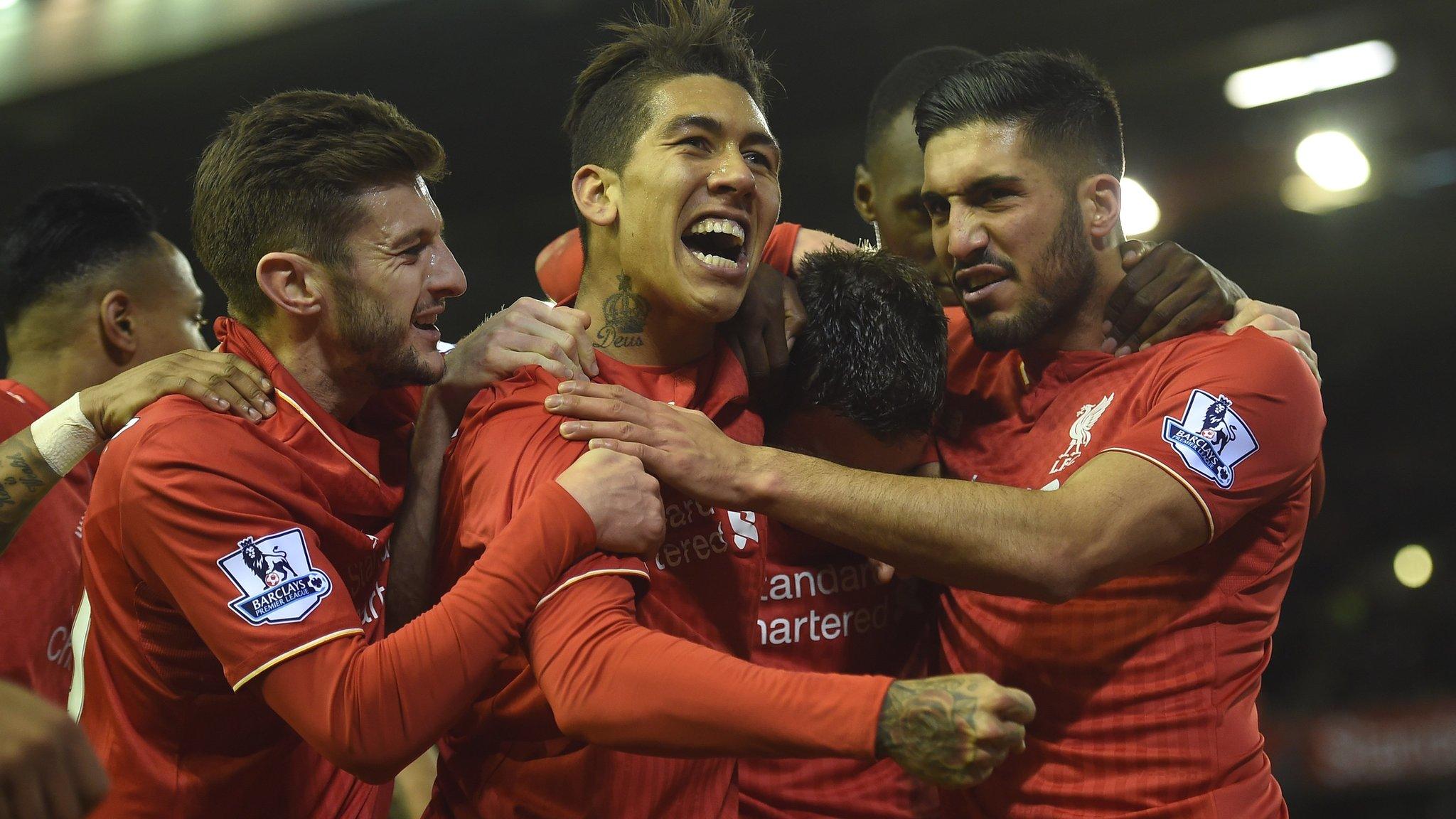 Liverpool players celebrate their winner against Swansea