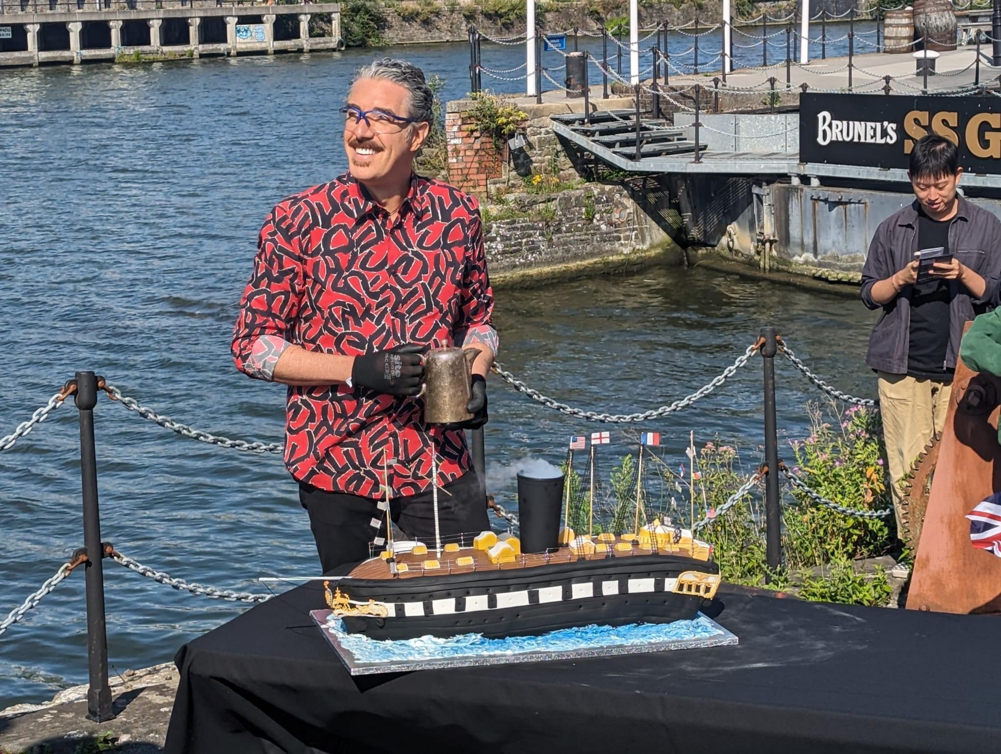 Giuseppe Dell'Anno in front of the SS Great Britain cake replica