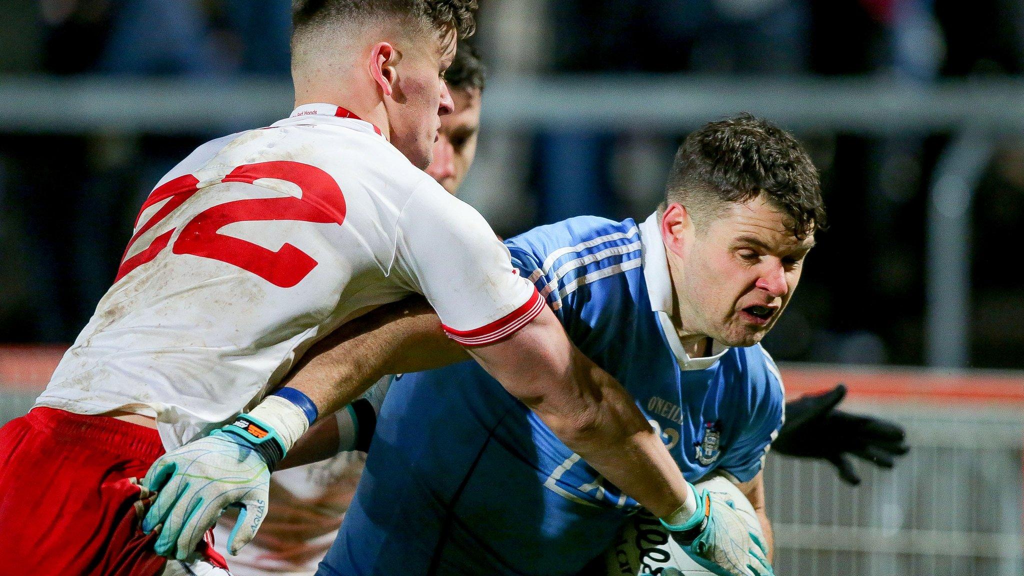 Tyrone's Michael McKernan tackles Dublin forward Kevin Mcmanamon