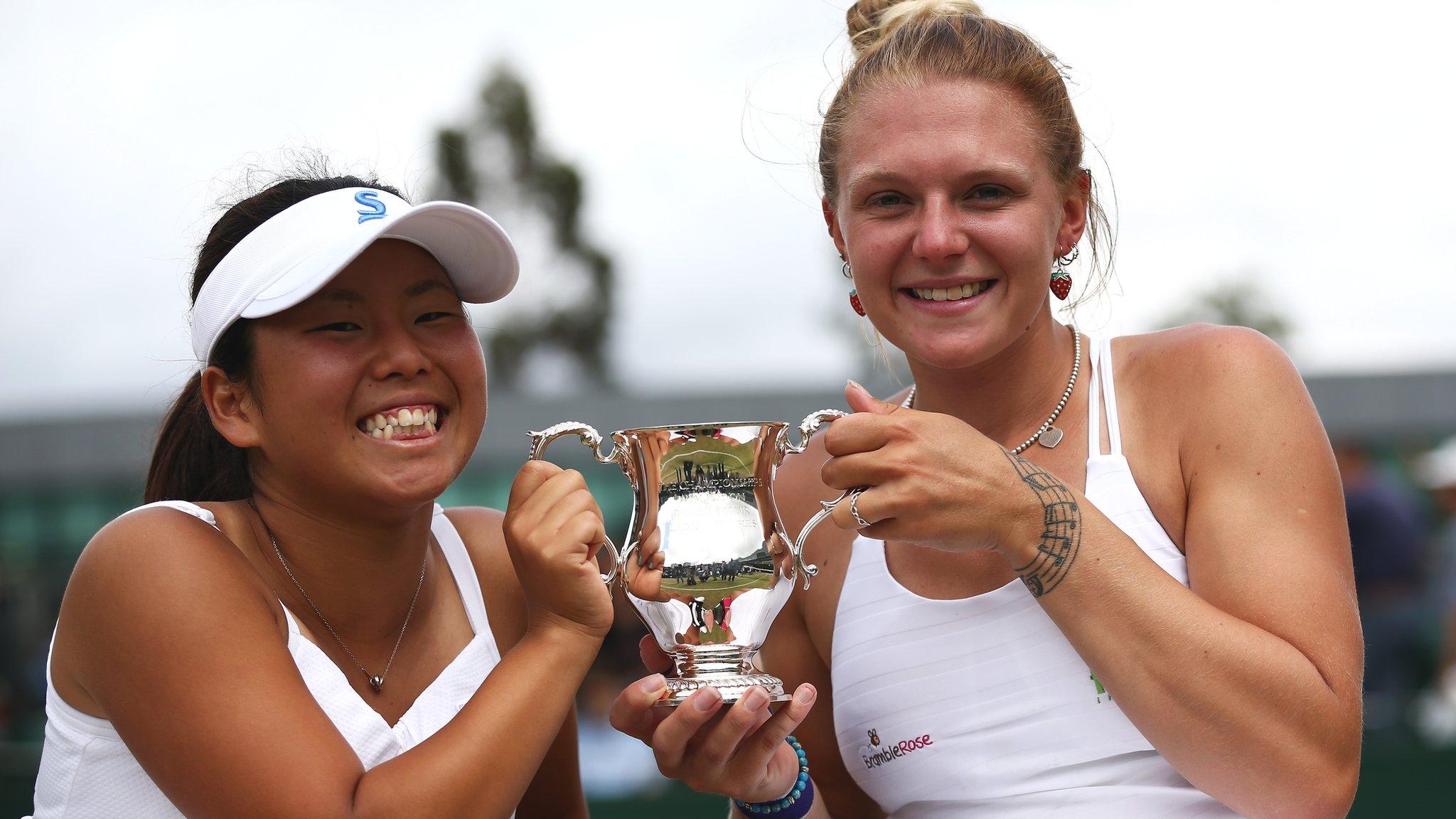 Jordanne and Yui holding their Wimbledon trophy