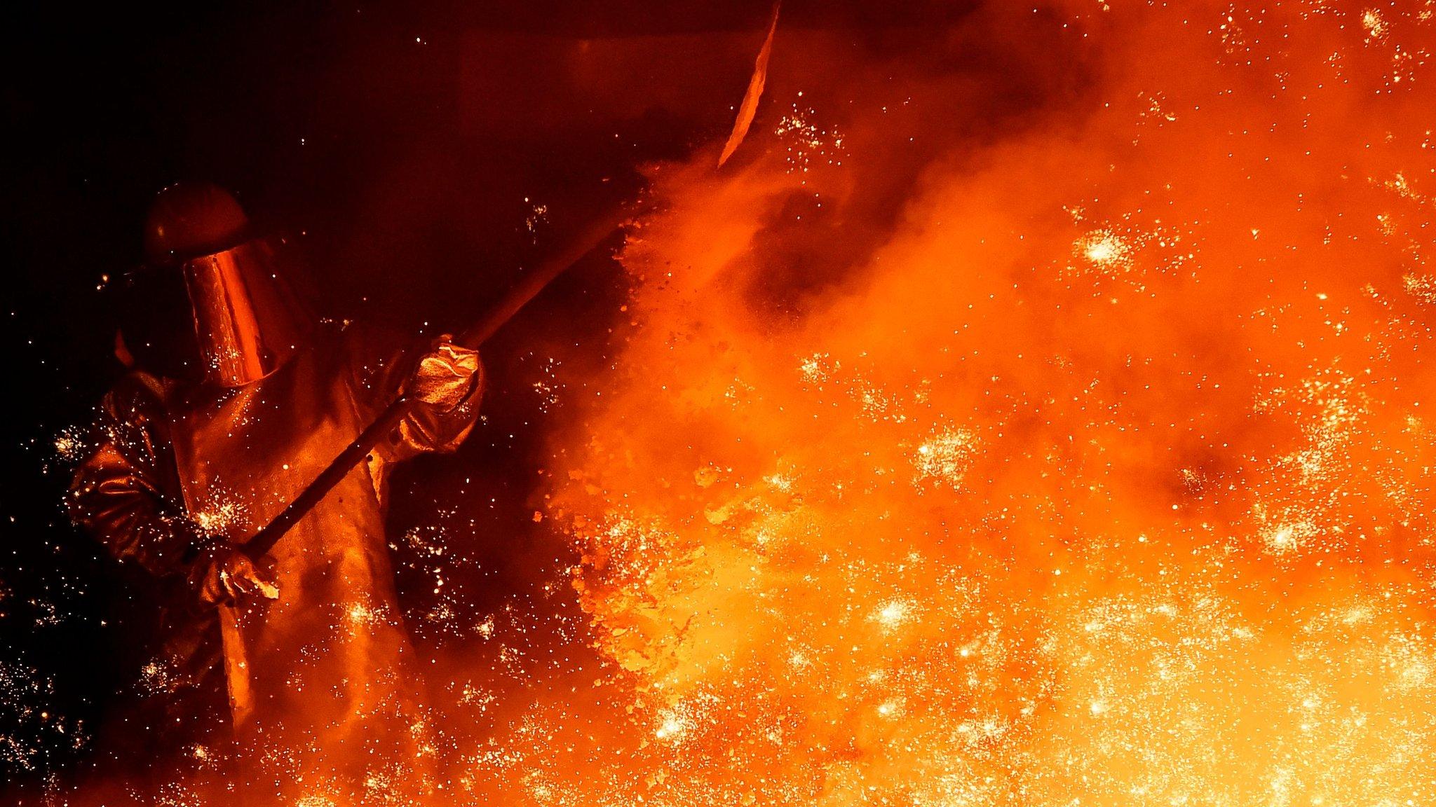 A steel worker at a furnace of German plant in Salzgitter