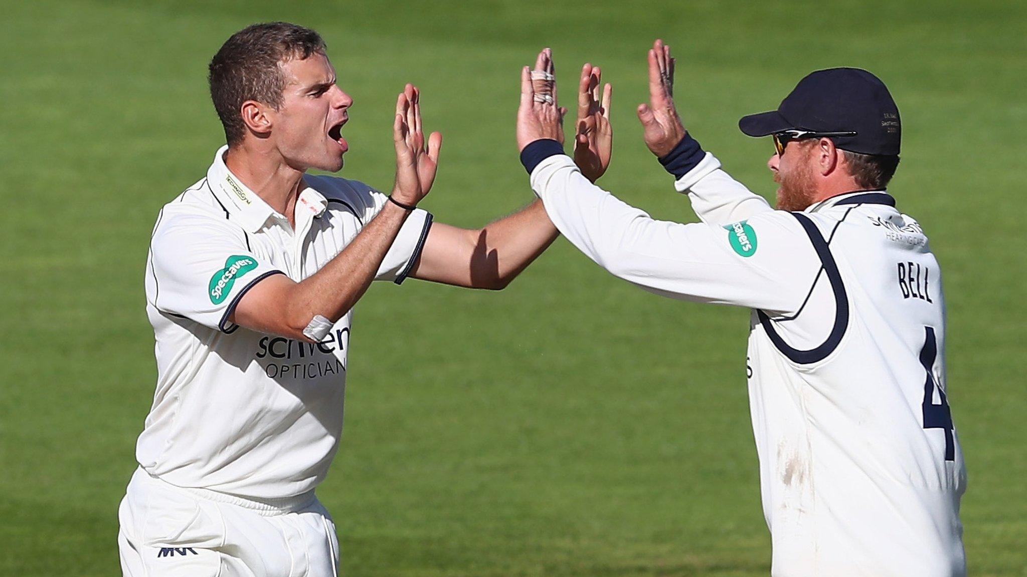 Warwickshire legspinner Josh Poysden celebrates taking the wicket of Stephen Eskinazi with Bears captain Ian Bell