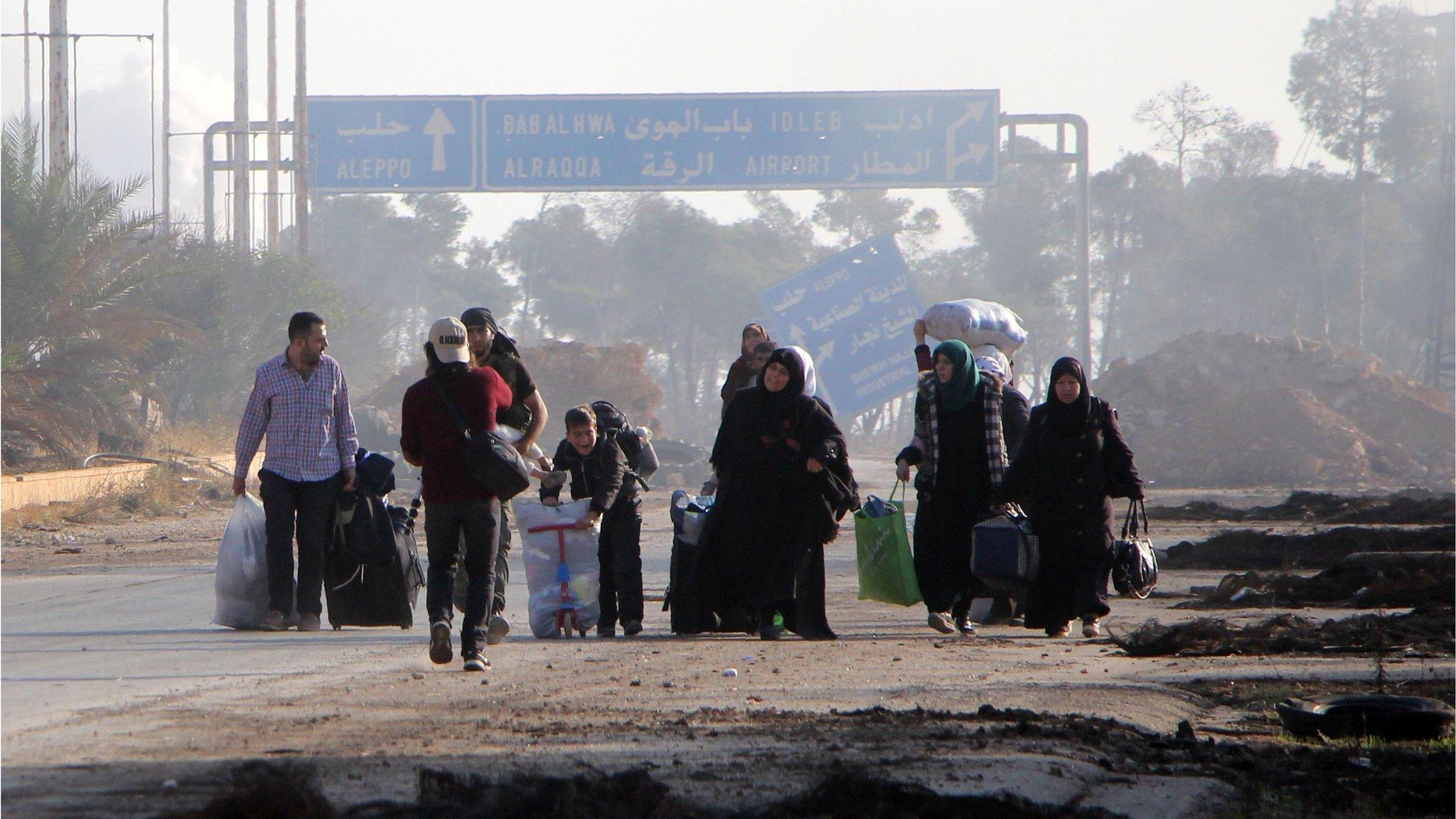 Civilians leave the frontline neighbourhood of Dahiyet al-Assad in western Aleppo