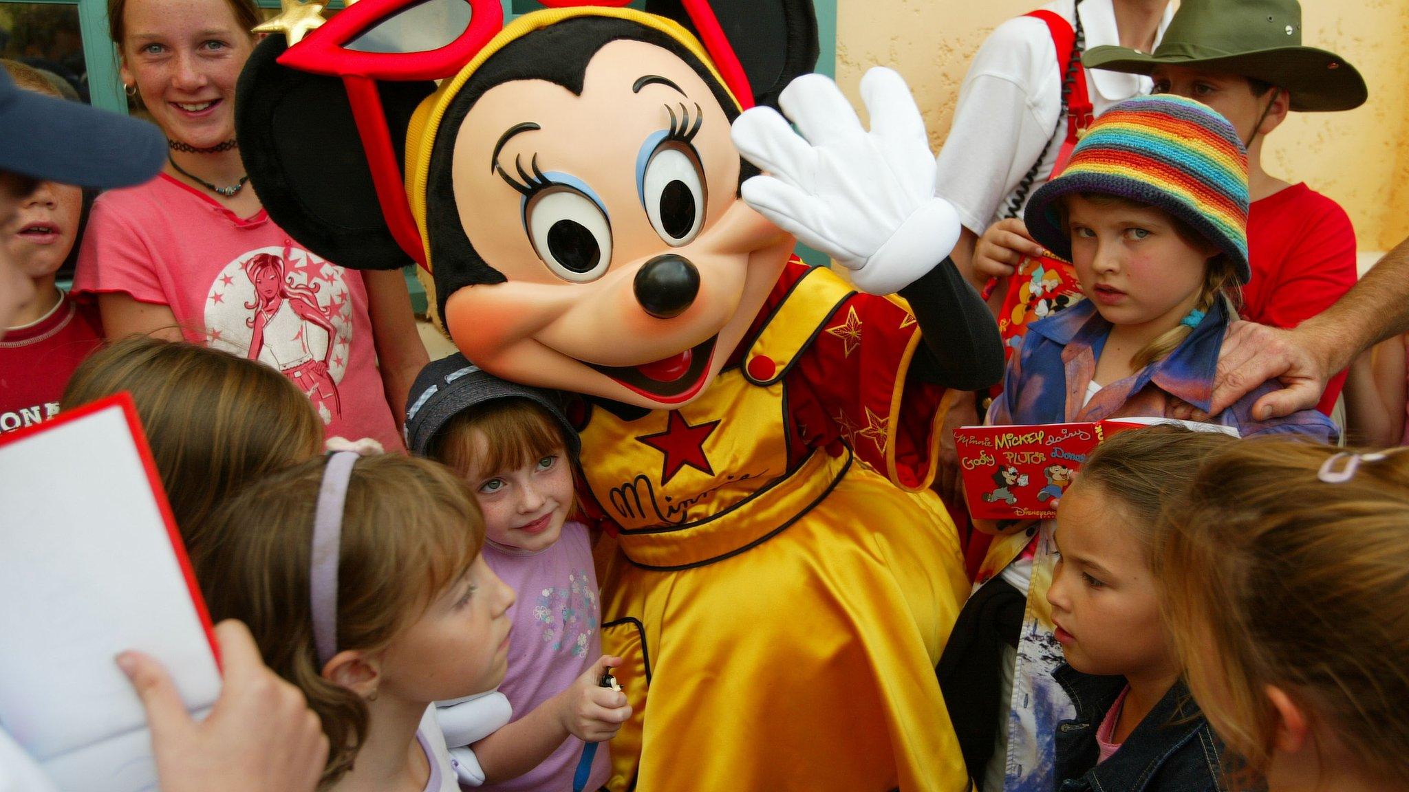 Minnie poses with children in the street of the Walt Disney Studios Park August 22, 2002 in Marne la Vallee, France.