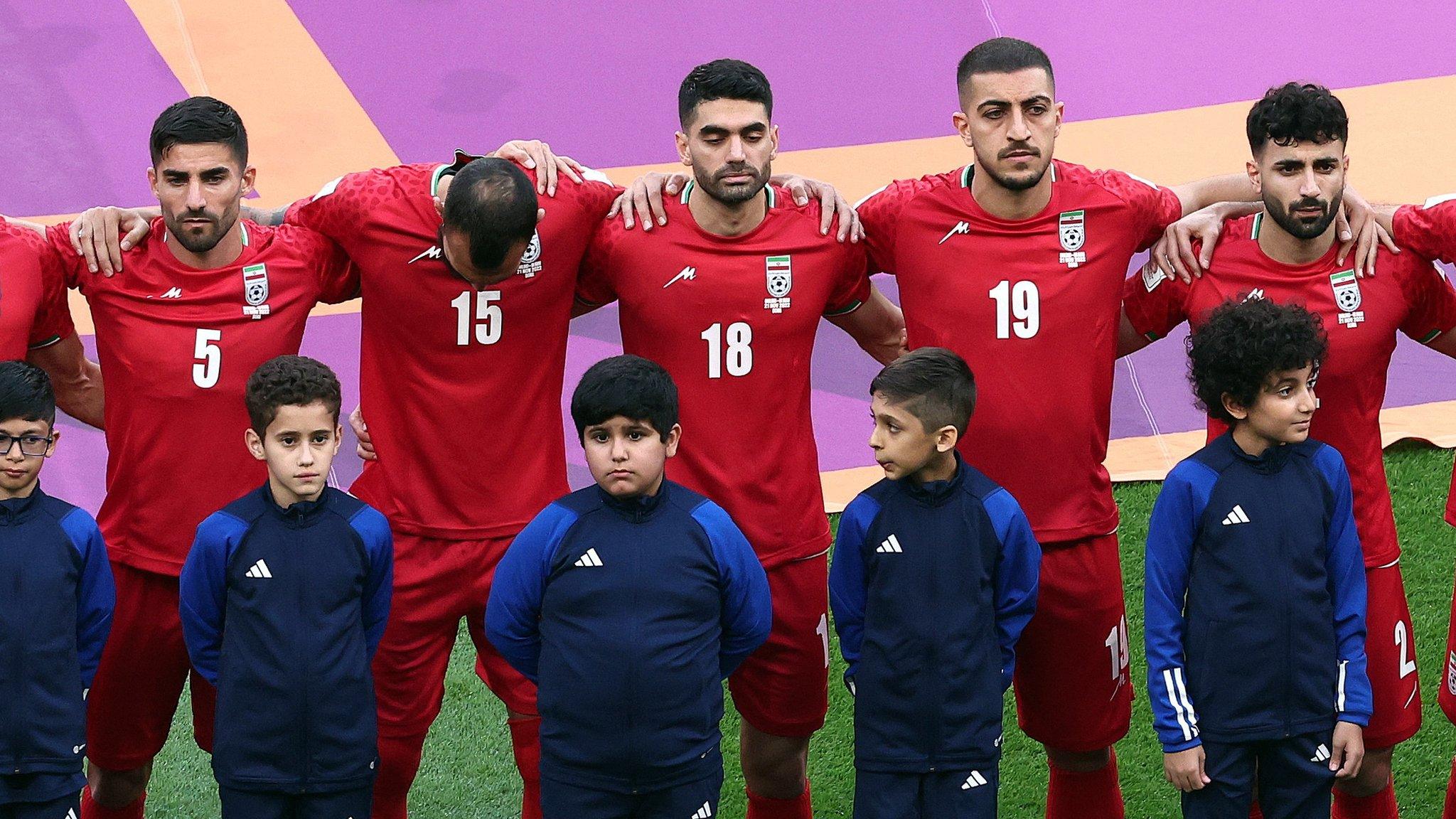 Iran players standing in silence during the national anthem