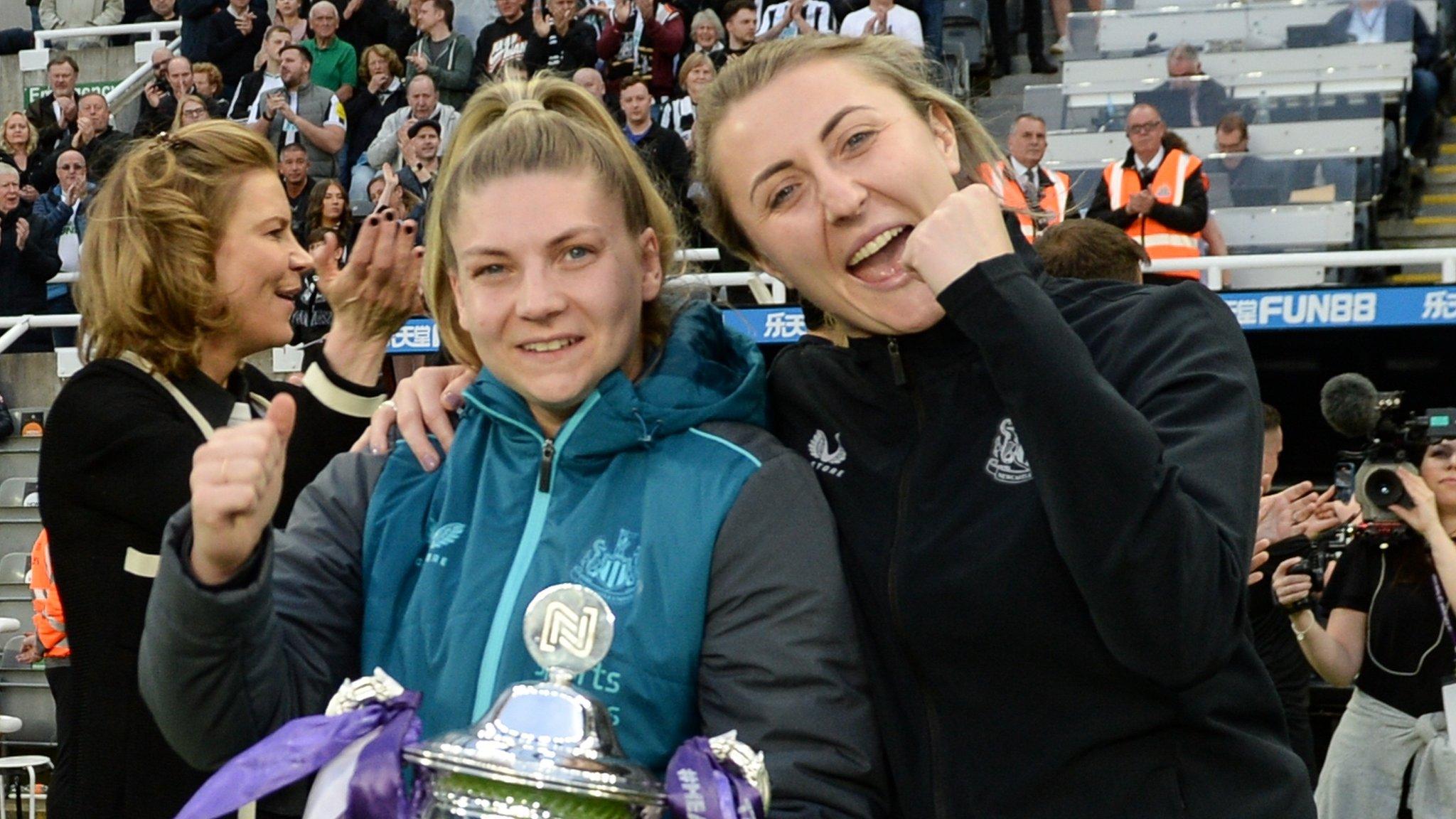 Newcastle women's team show off their league title with Grace Donnelly (holding cup) and team manager Becky Langley