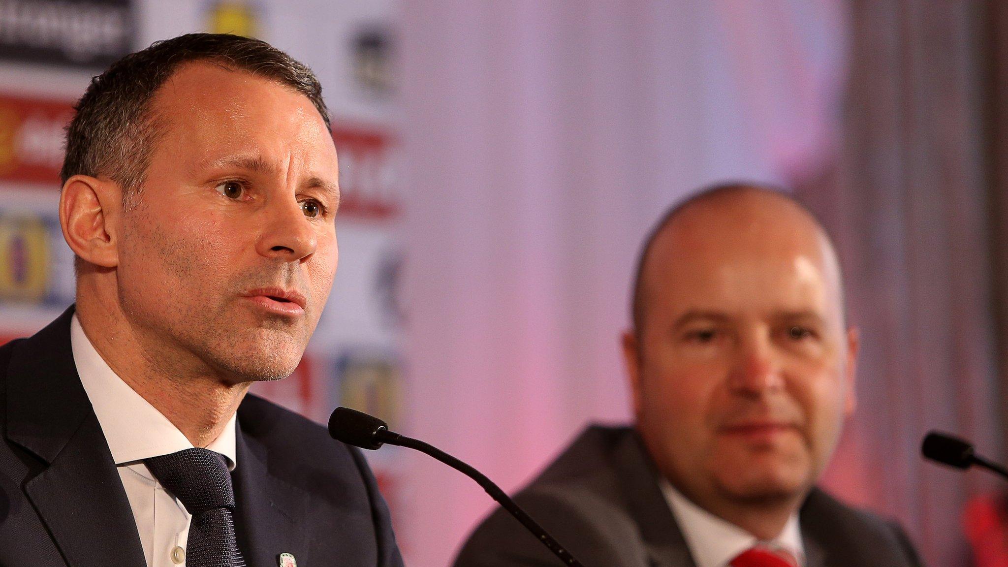 Ryan Giggs addresses the media, watched by FAW chief executive Jonathan Ford