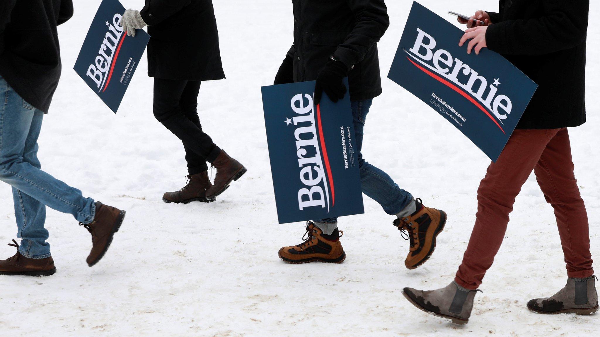 Supporters of US presidential candidate Bernie Sanders hold placards