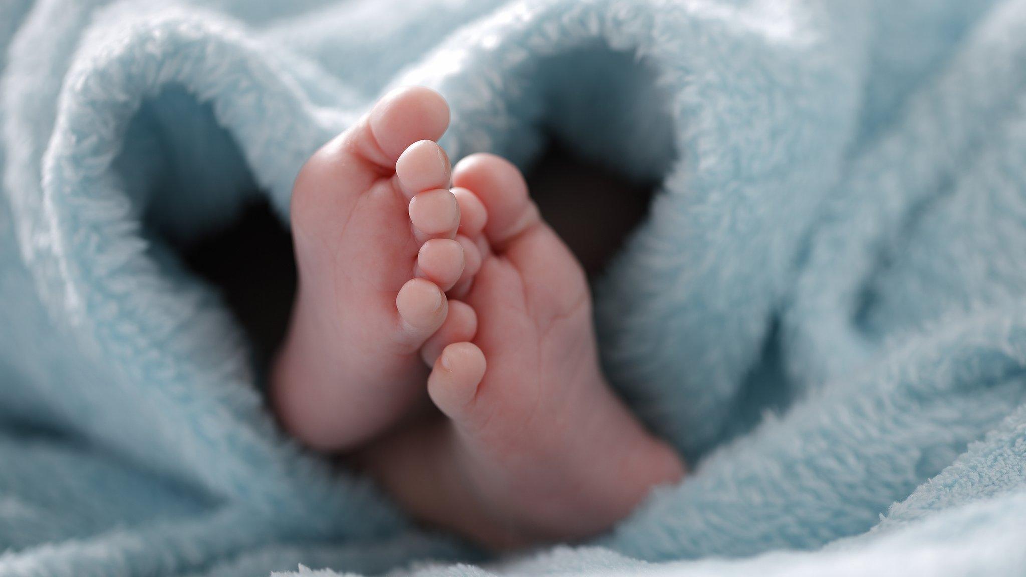 Baby's feet sticking out of a blanket