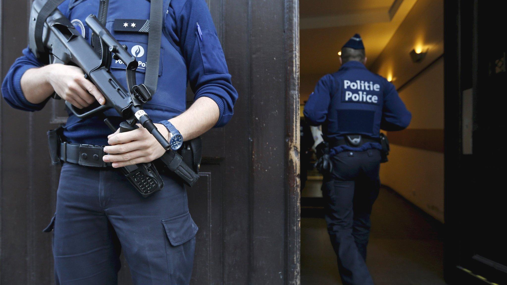 A Belgian police officer stands guard at the entrance of the Brussels" central police headquarters, December 29, 2015,