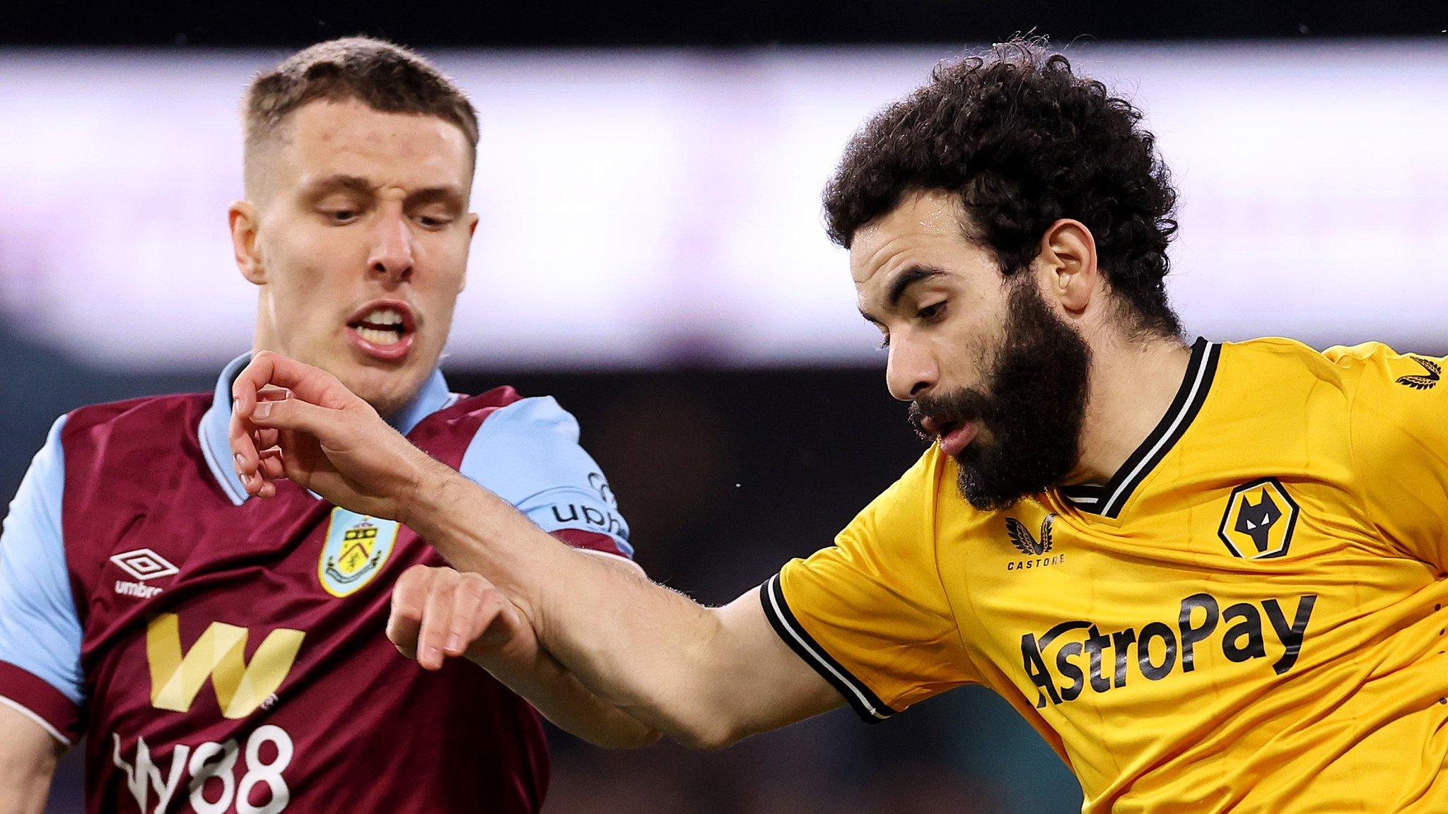 Burnley and Wolves players battle for ball