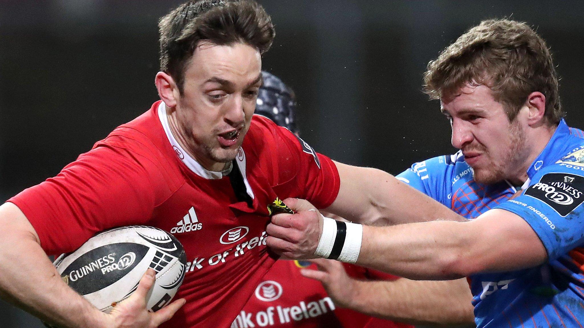 Munster's Darren Sweetnam is tackled by Scarlets centre Steff Hughes