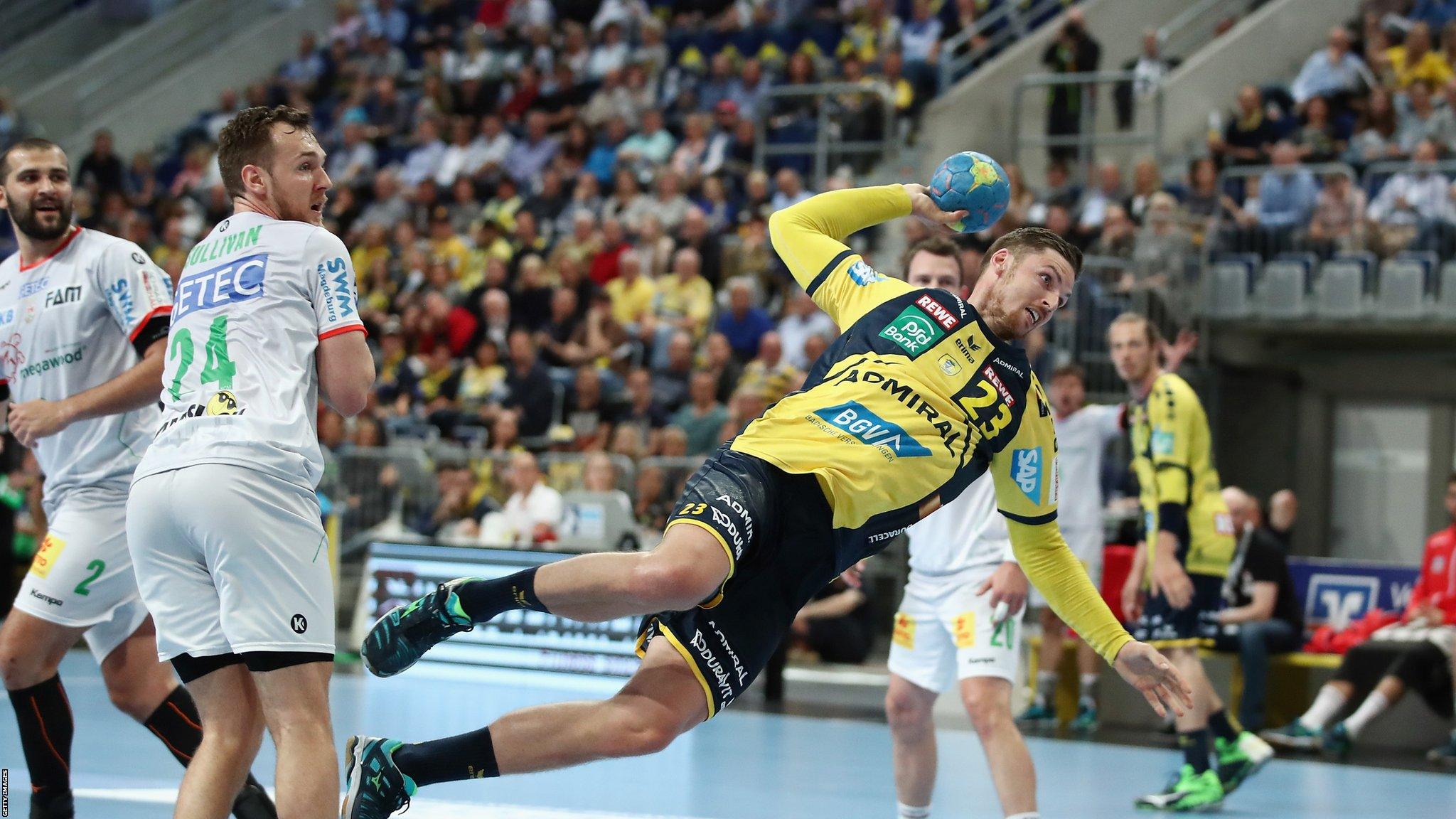 Mannheim, Germany, 10 May: Hendrik Pekeler produces an acrobatic finish for Rhein-Neckar Loewen against SC Magdeburg in their DKB handball match at SAP Arena, helping his side to a 34-29 win.