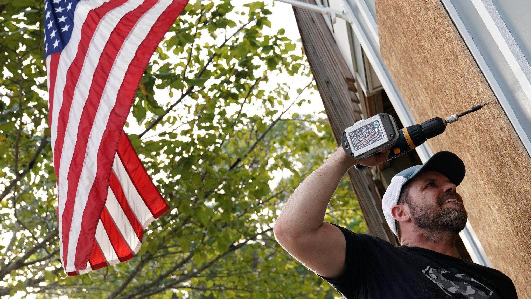 Man boards up house before hurricane