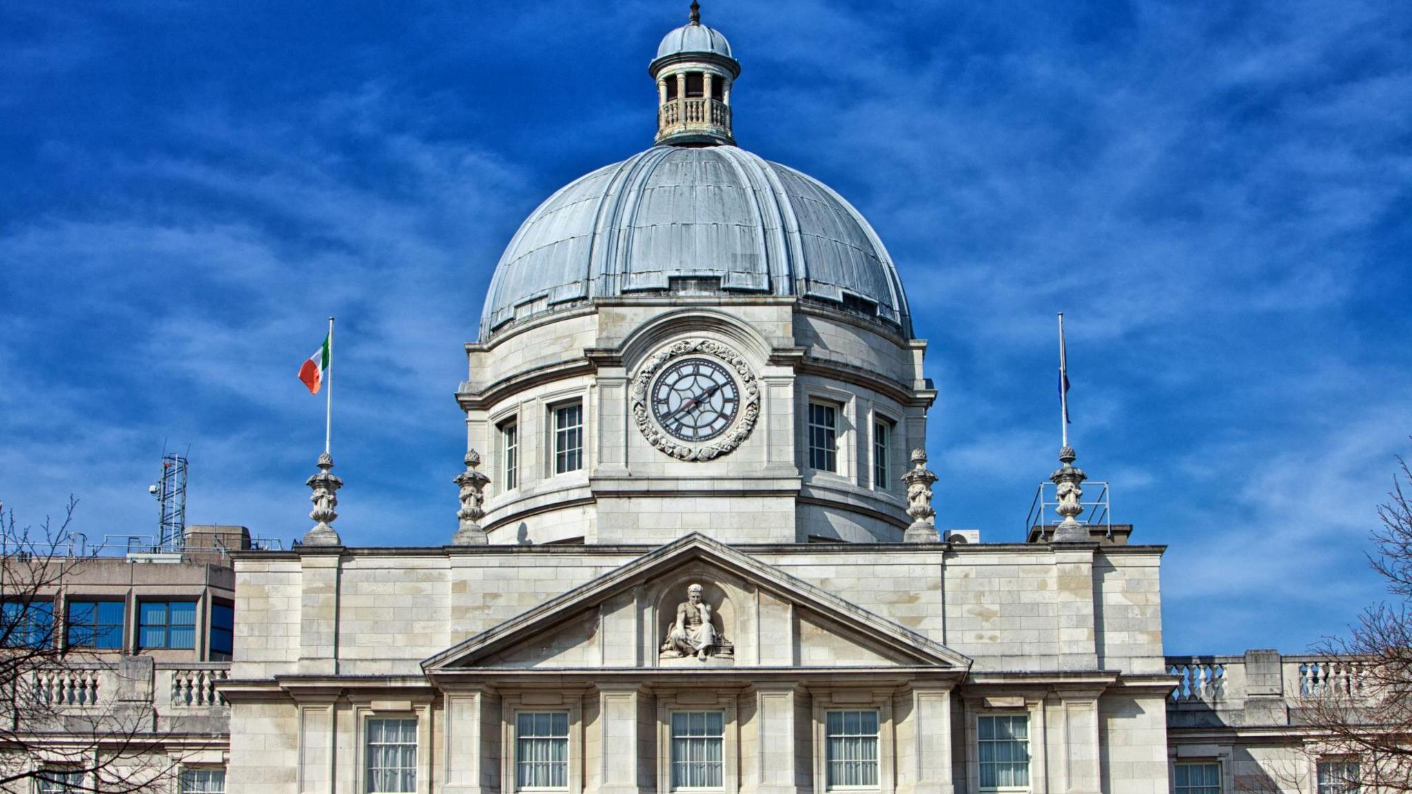 Leinster House - An exterior shot of a white stone building with a large blue-topped dome against a blue sky.