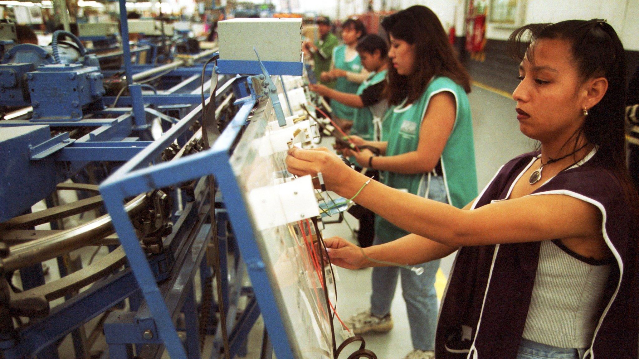 Workers make wire harnesses for automobiles in Ciudad Juarez, Mexico