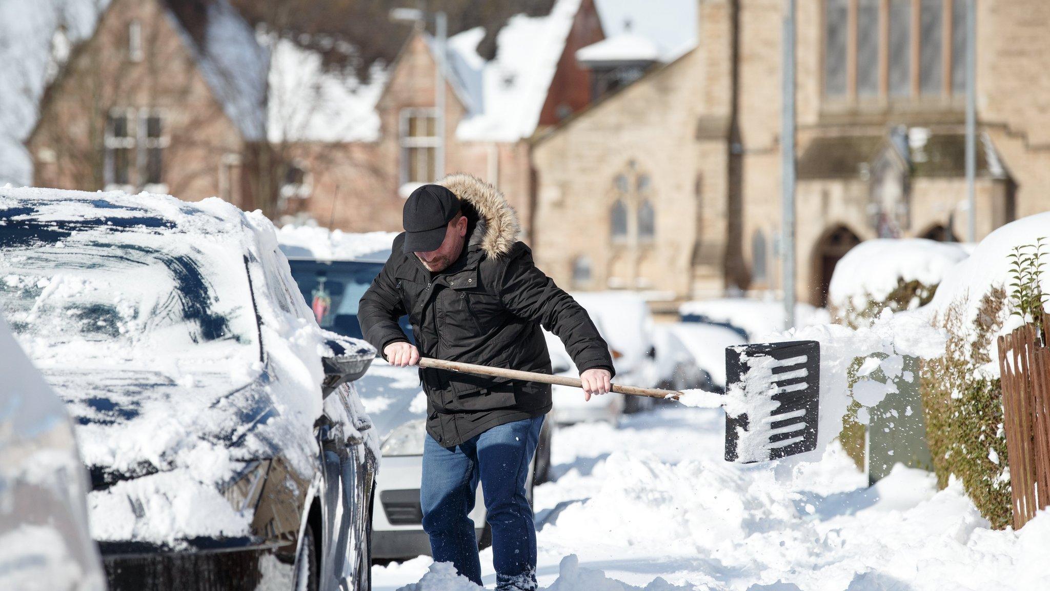 Man digs car out of snow