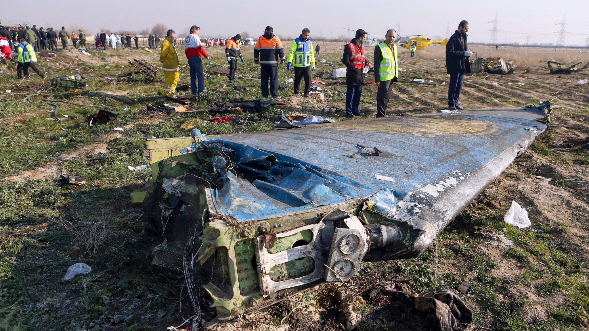 Rescue teams inspect the wreckage of Ukrainian International Airlines flight PS752