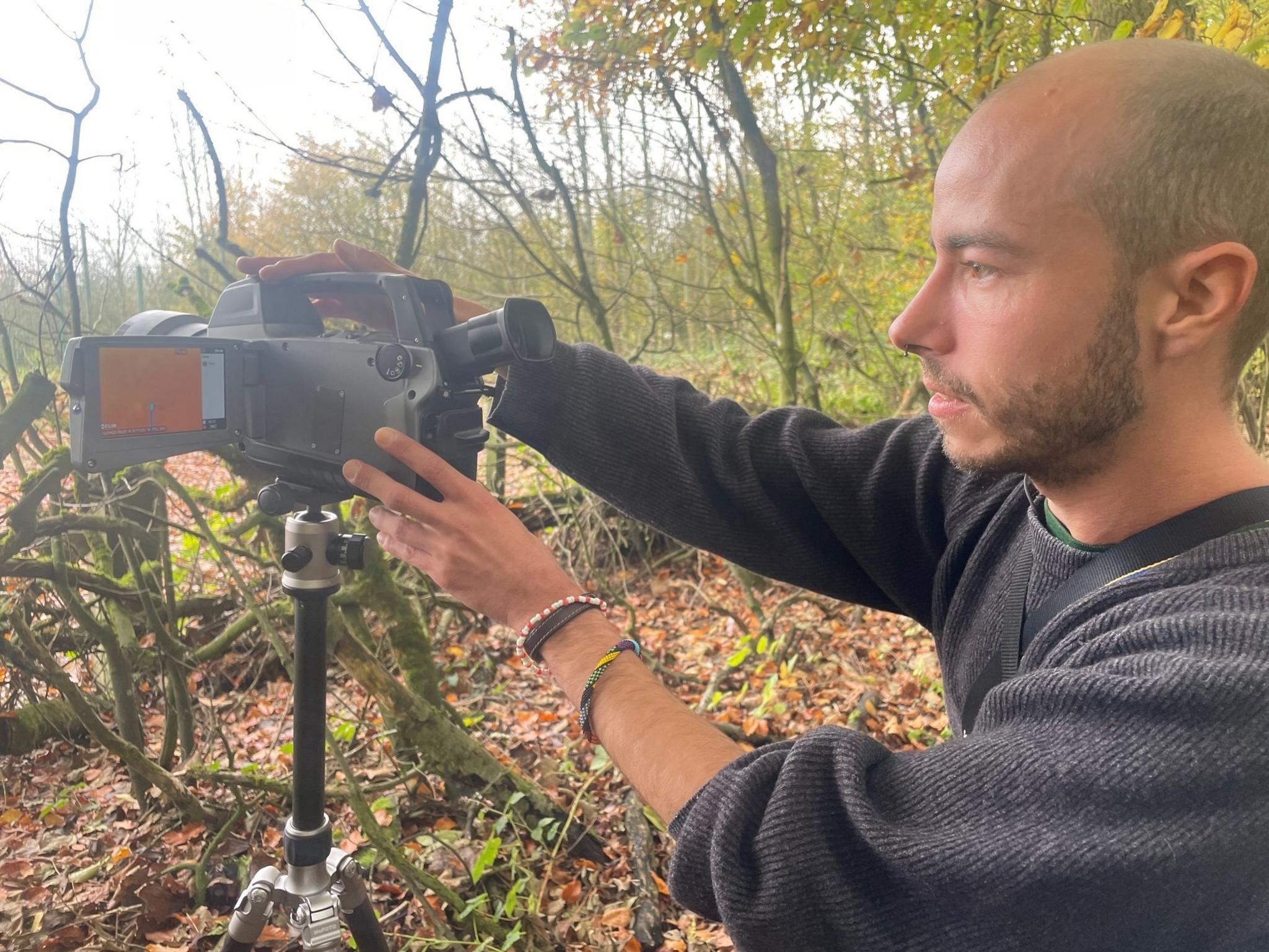 Man with gas imaging camera.