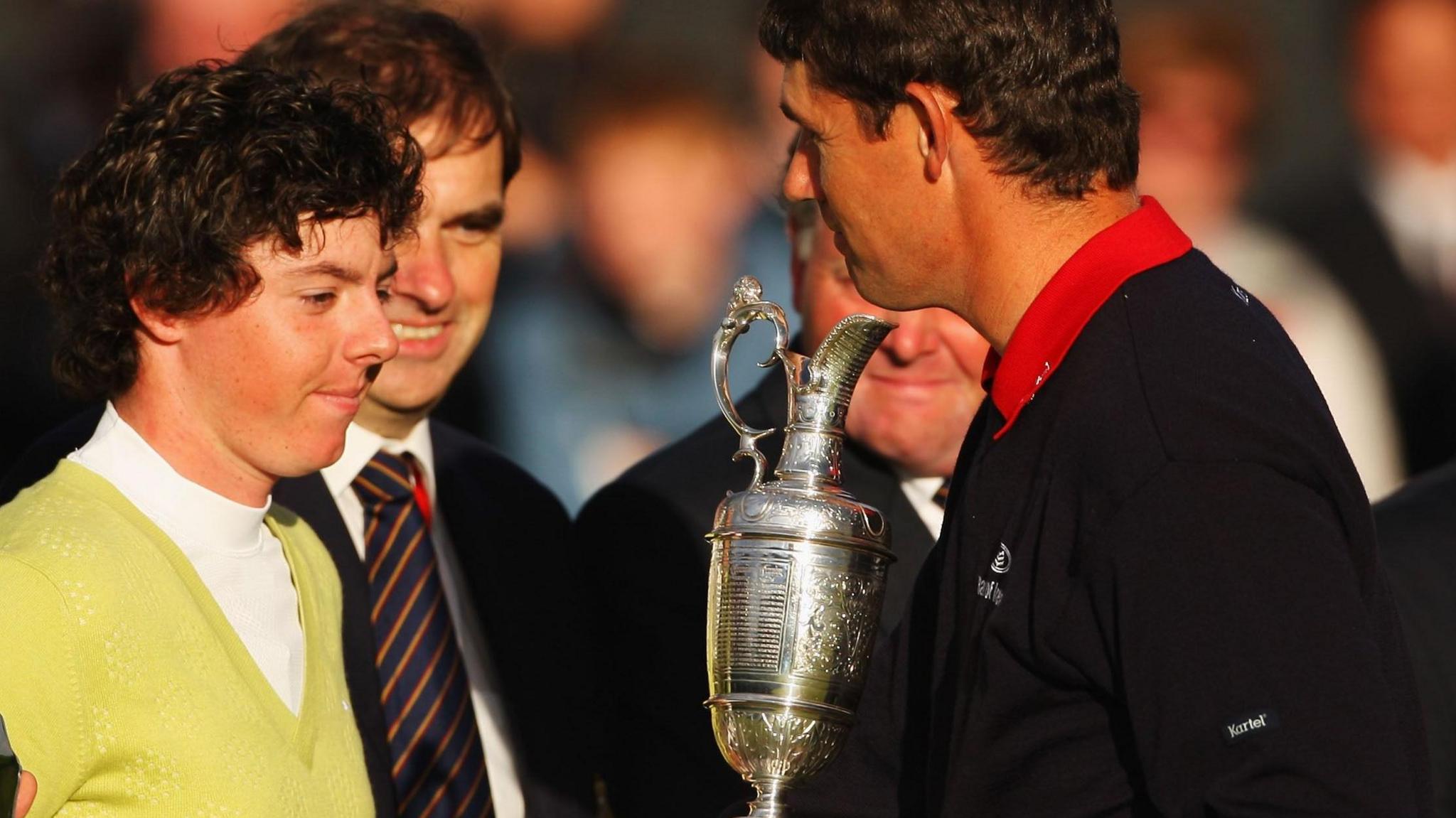 Padraig Harrington shakes hands with Sergio Garcia after beating him to the 2007 Open Championship title, while holding the Claret Jug and Rory McIlroy looks on