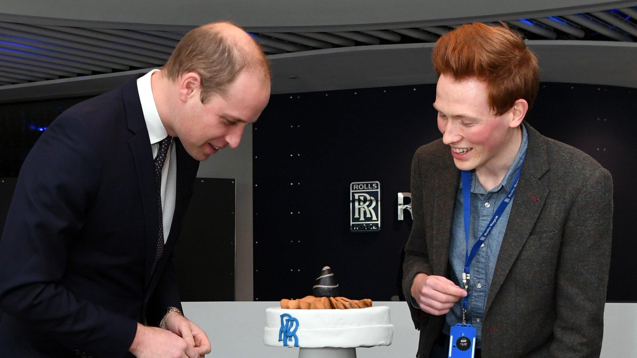 Prince William (L), Duke of Cambridge is presented with a cake by Aerospace engineer and Bake Off runner-up Aero Andrew Smyth during a visit to the Rolls Royce technology centre in Derby, central England on November 30, 2016