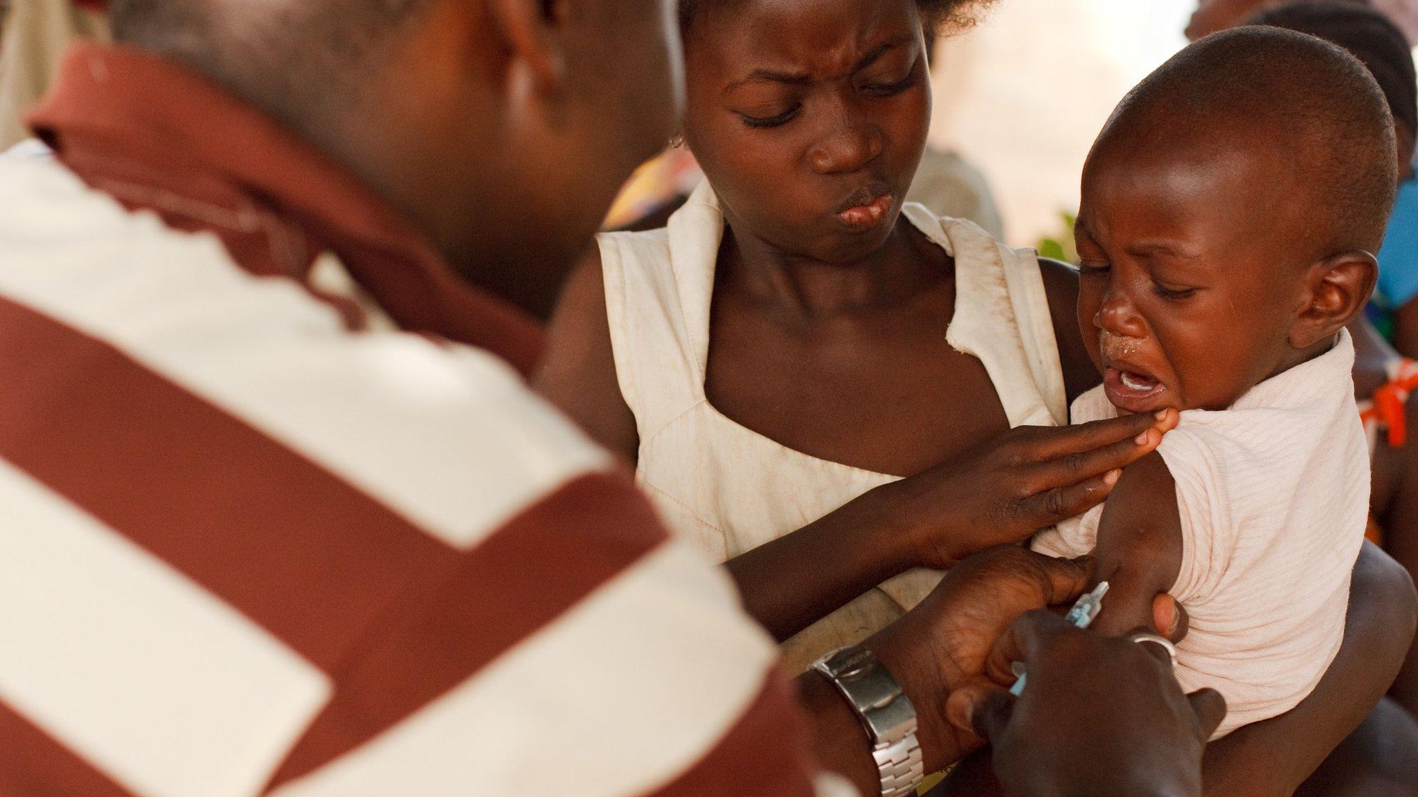 In this Saturday, Jan. 22, 2011 file photo, a health worker injects a young boy with yellow fever vaccine in Seguela in northern Ivory Coast.