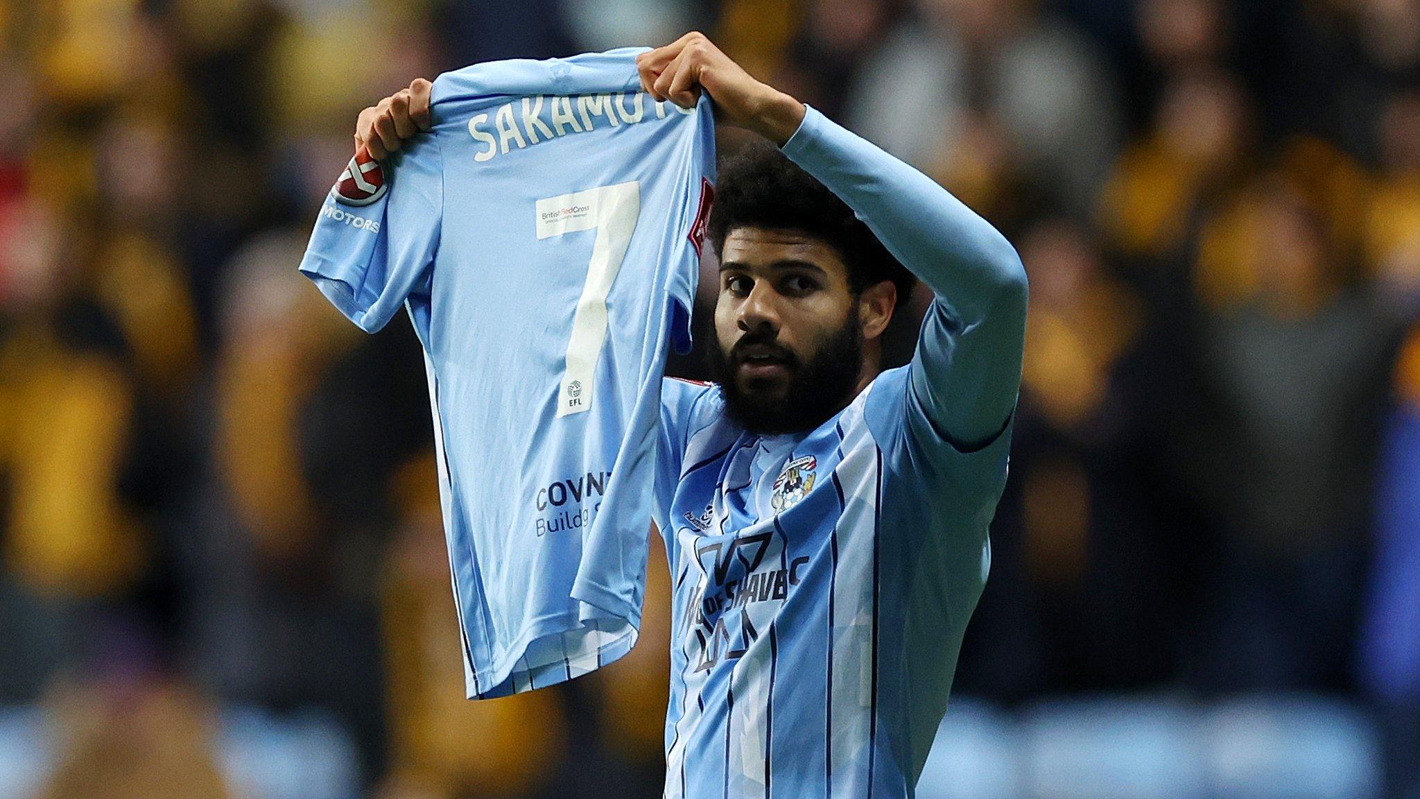 Ellis Simms of Coventry City celebrates scoring his team's first goal whilst holding the shirtt of injured team mate Tatsuhiro Sakamoto during the Emirates FA Cup Fifth Round match between Coventry City and Maidstone United at The Coventry Building Society Arena on February 26, 2024 in Coventry, England