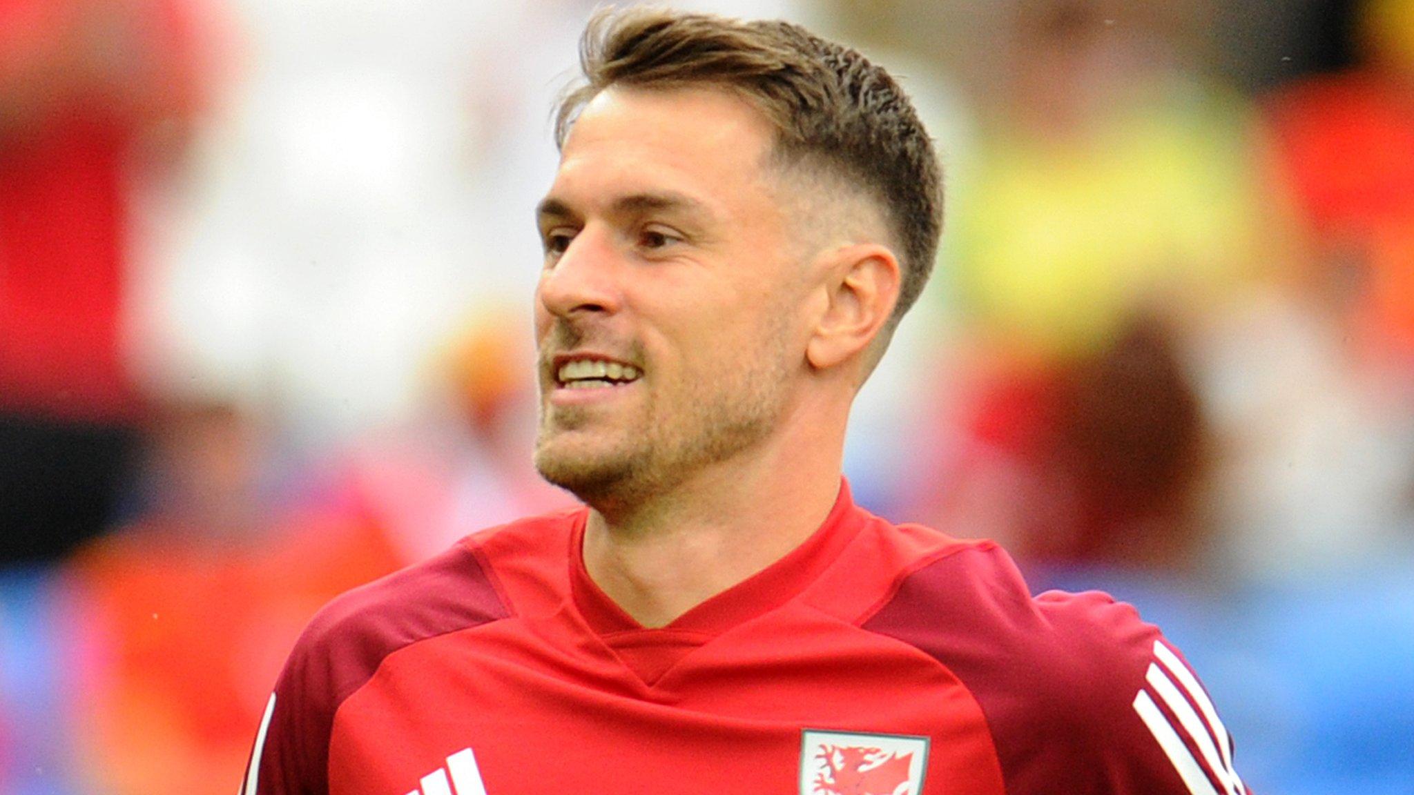 Aaron Ramsey warms up with Wales in June