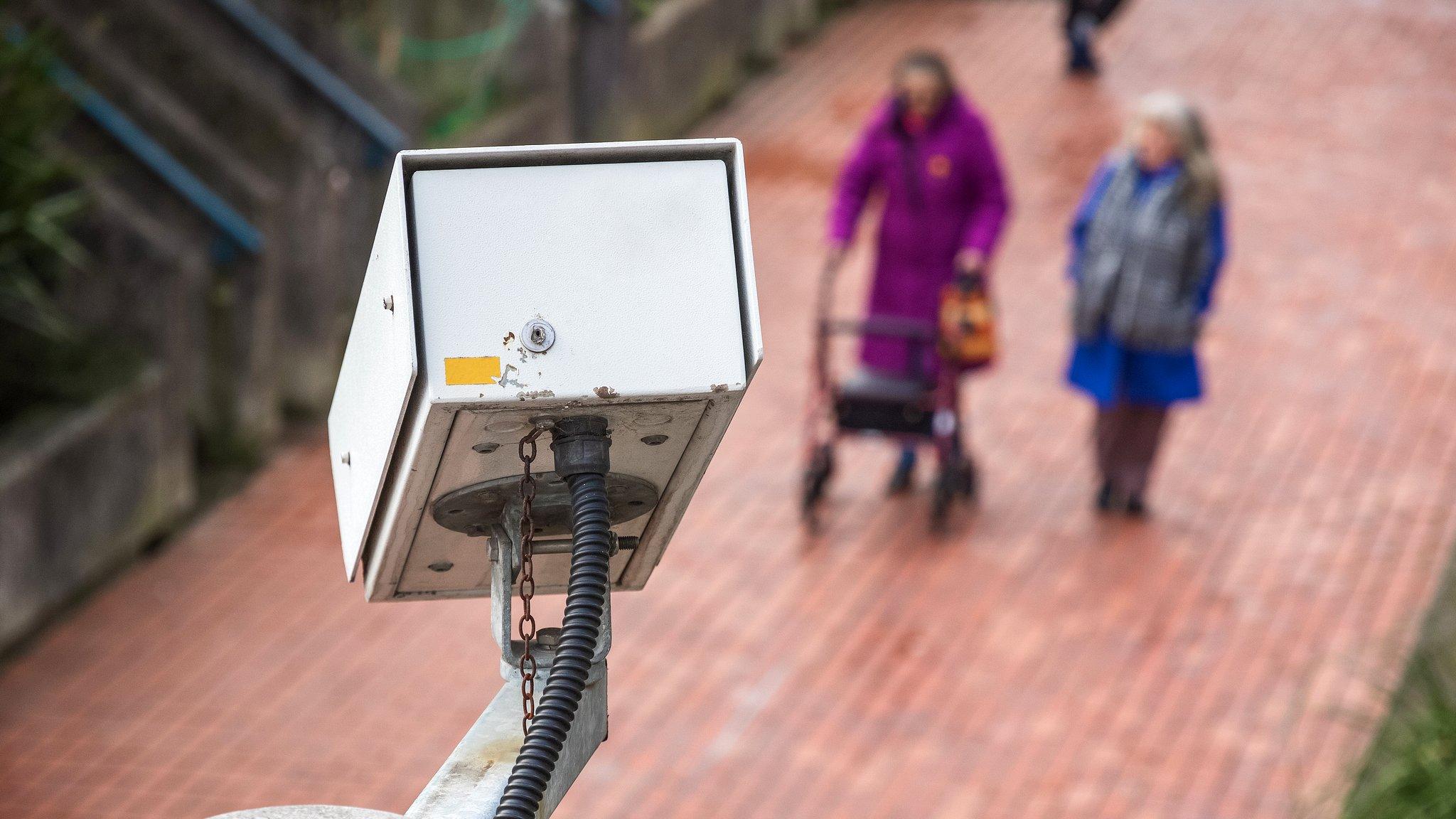 A security camera watching a street