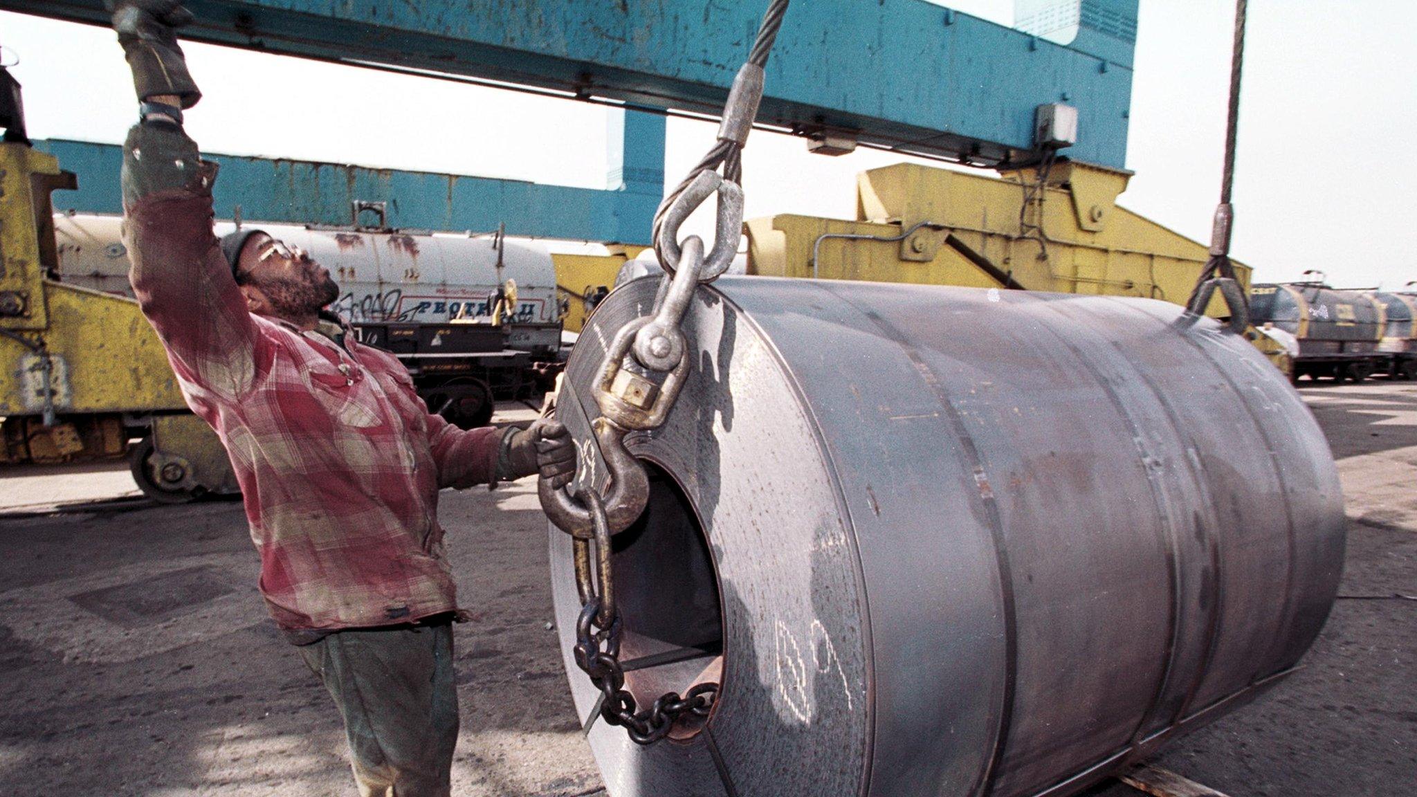 An employee of the South Jersey Port Corporation in Camden NJ with a coil of imported steel