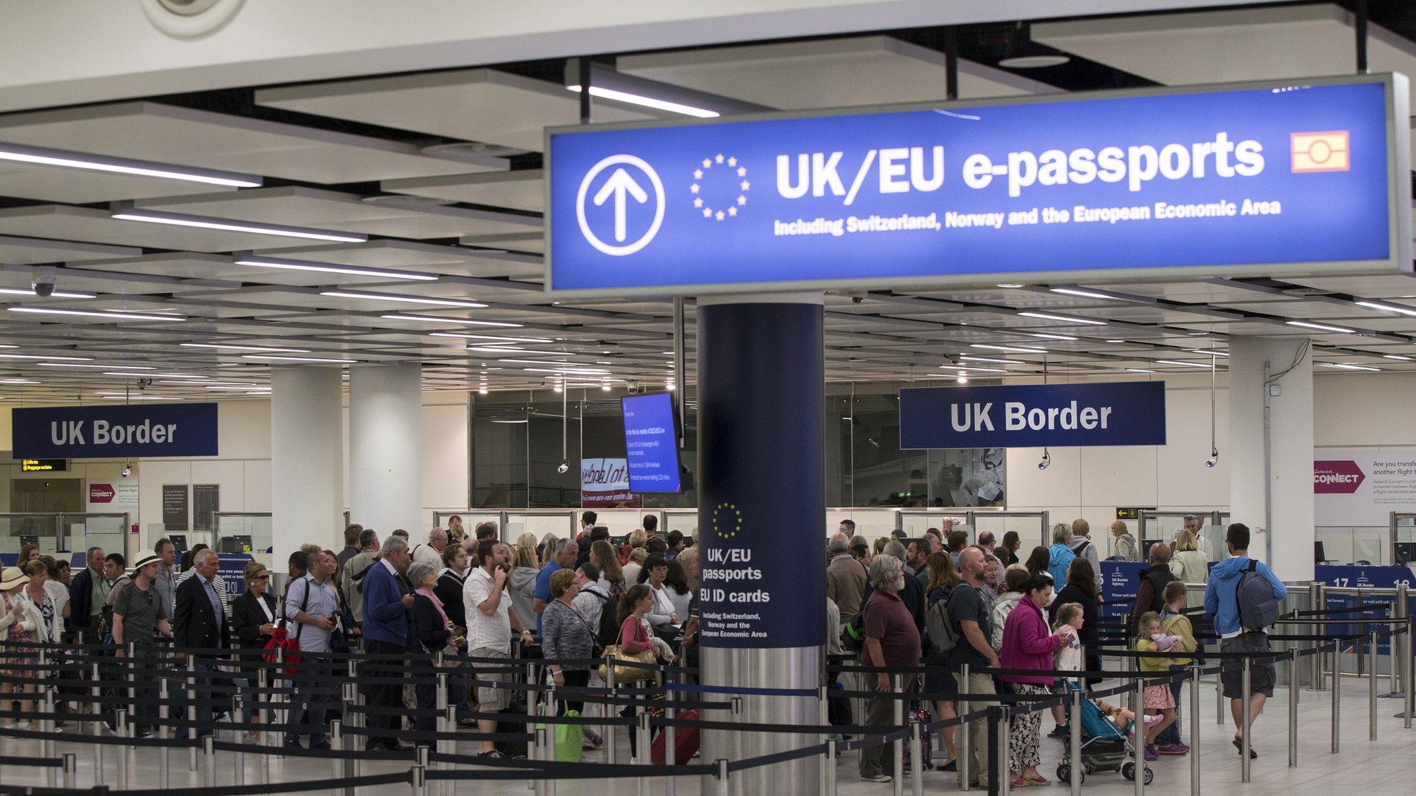 Border Force check the passports of passengers arriving at Gatwick Airport