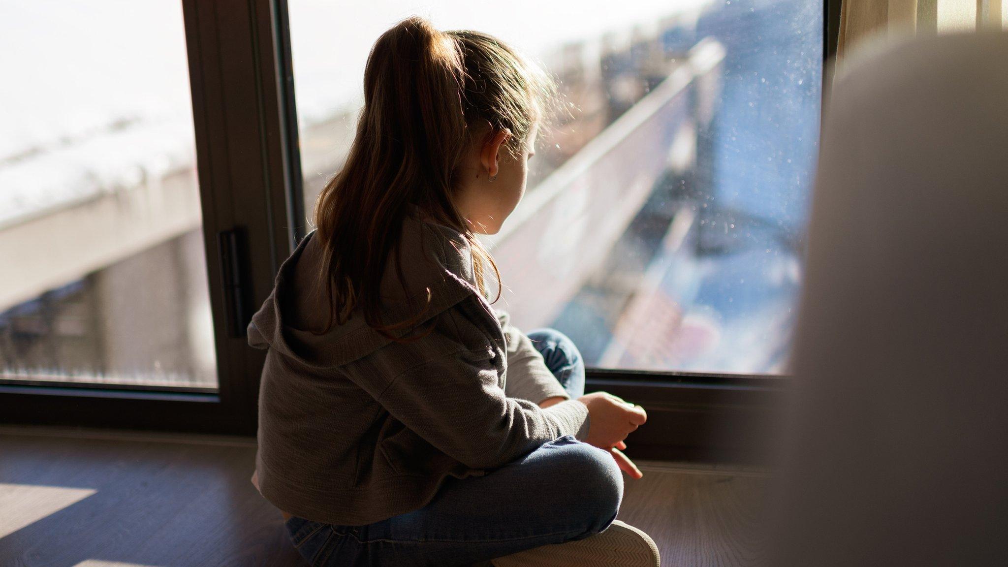 girl-looking-out-of-window.