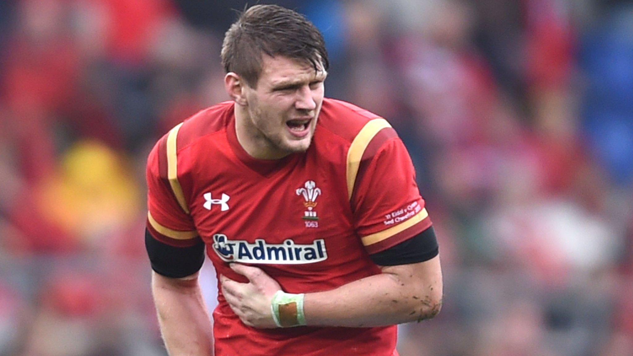 Dan Biggar feels his ribs before departing against Italy in Rome