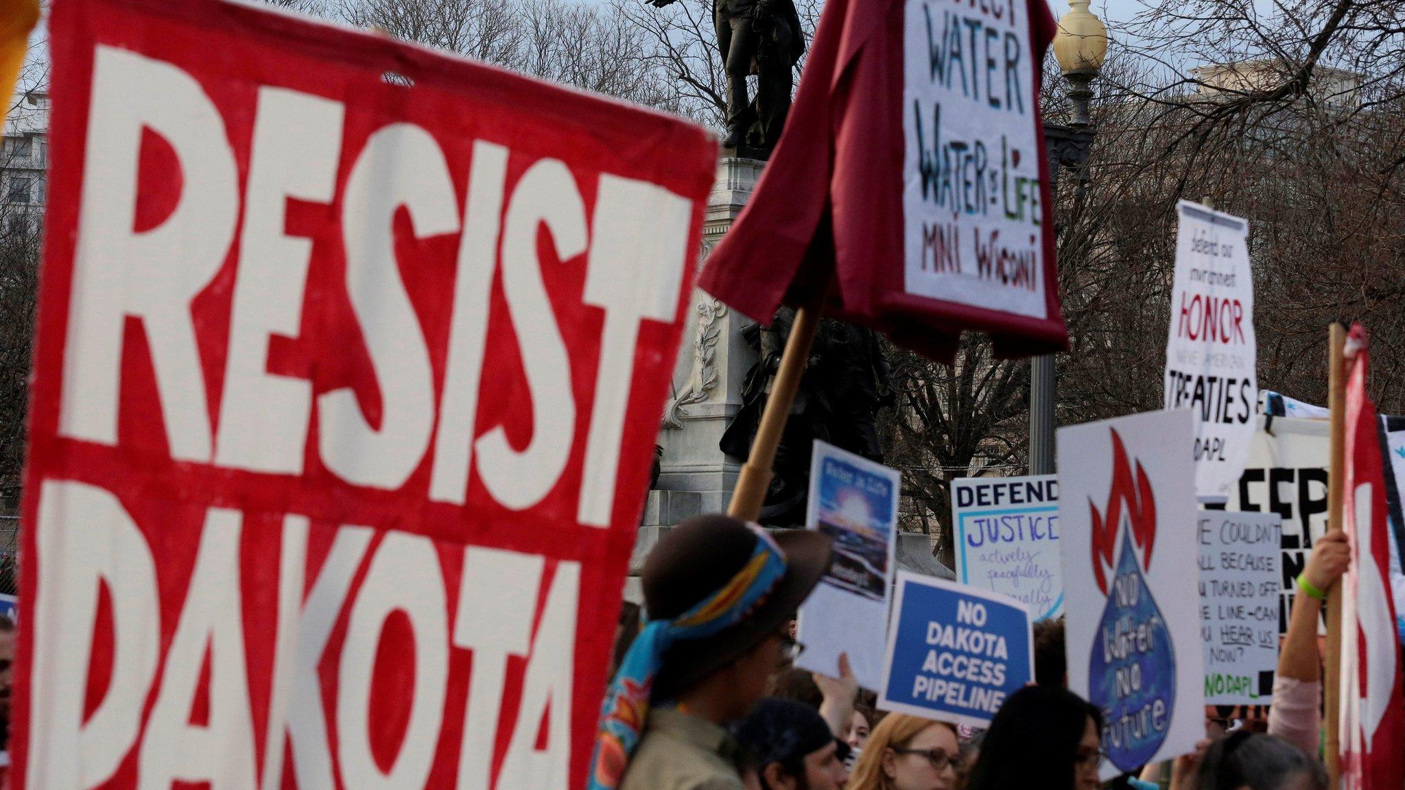 People protest under the statue of Lafayette against U.S. President Donald Trump"s directive to permit the Dakota Access Pipeline during a demonstration at the White House in Washington, U.S., February 8, 2017