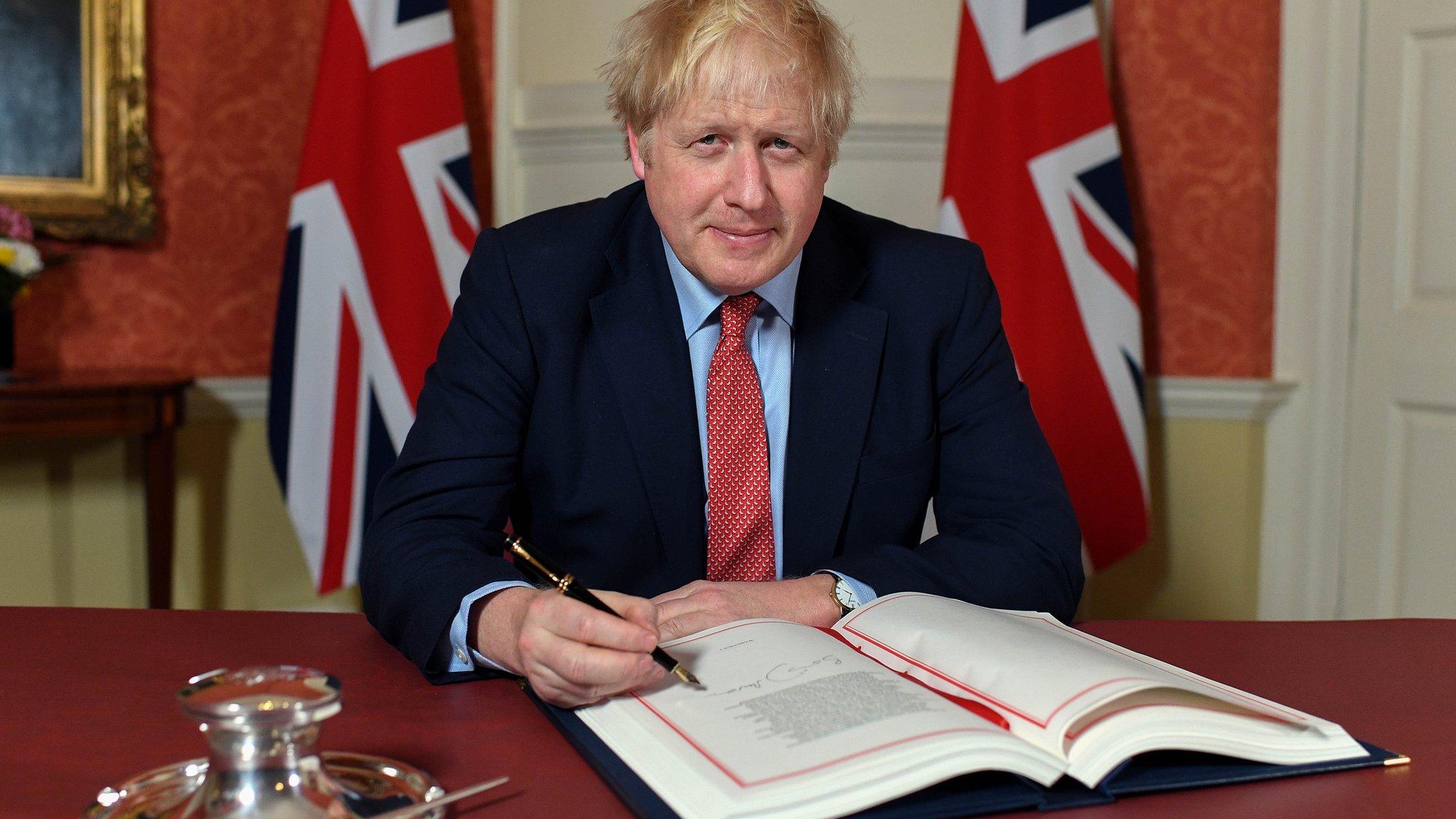 Boris Johnson signing Withdrawal Agreement