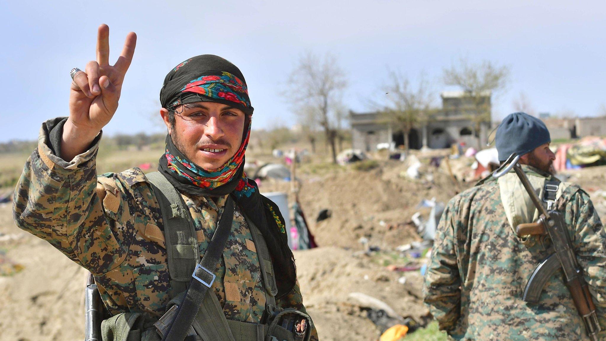 A picture taken on March 23, 2019 shows a fighter of the US-backed Kurdish-led Syrian Democratic Forces (SDF)