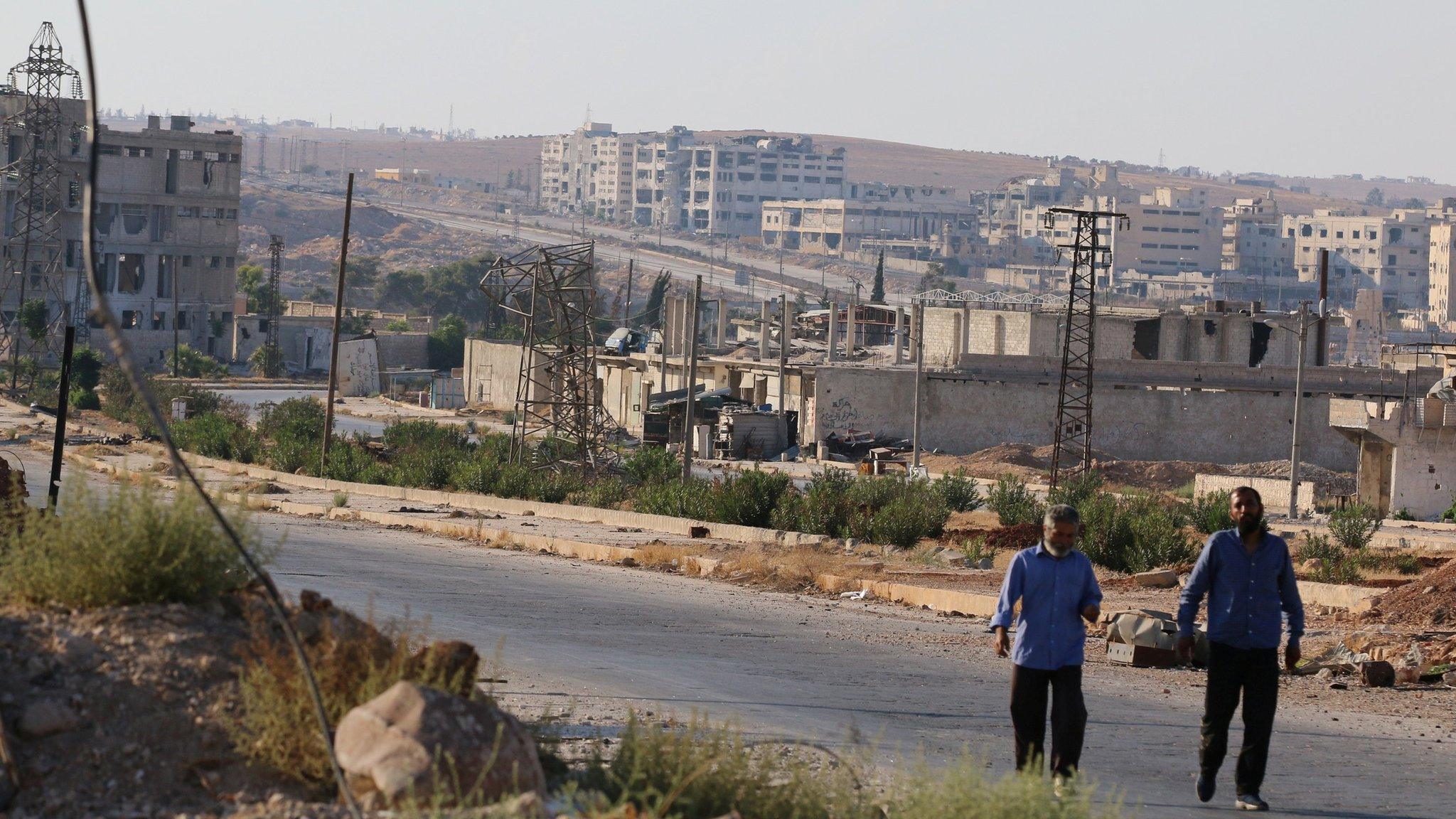 People walk near the Castello Road in Aleppo (14 September 2016)