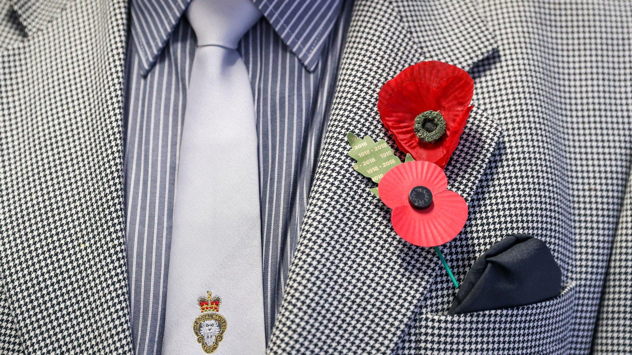 Bernie Axtell, 77, wears a poppy believed to date back to before World War Two next to a modern one